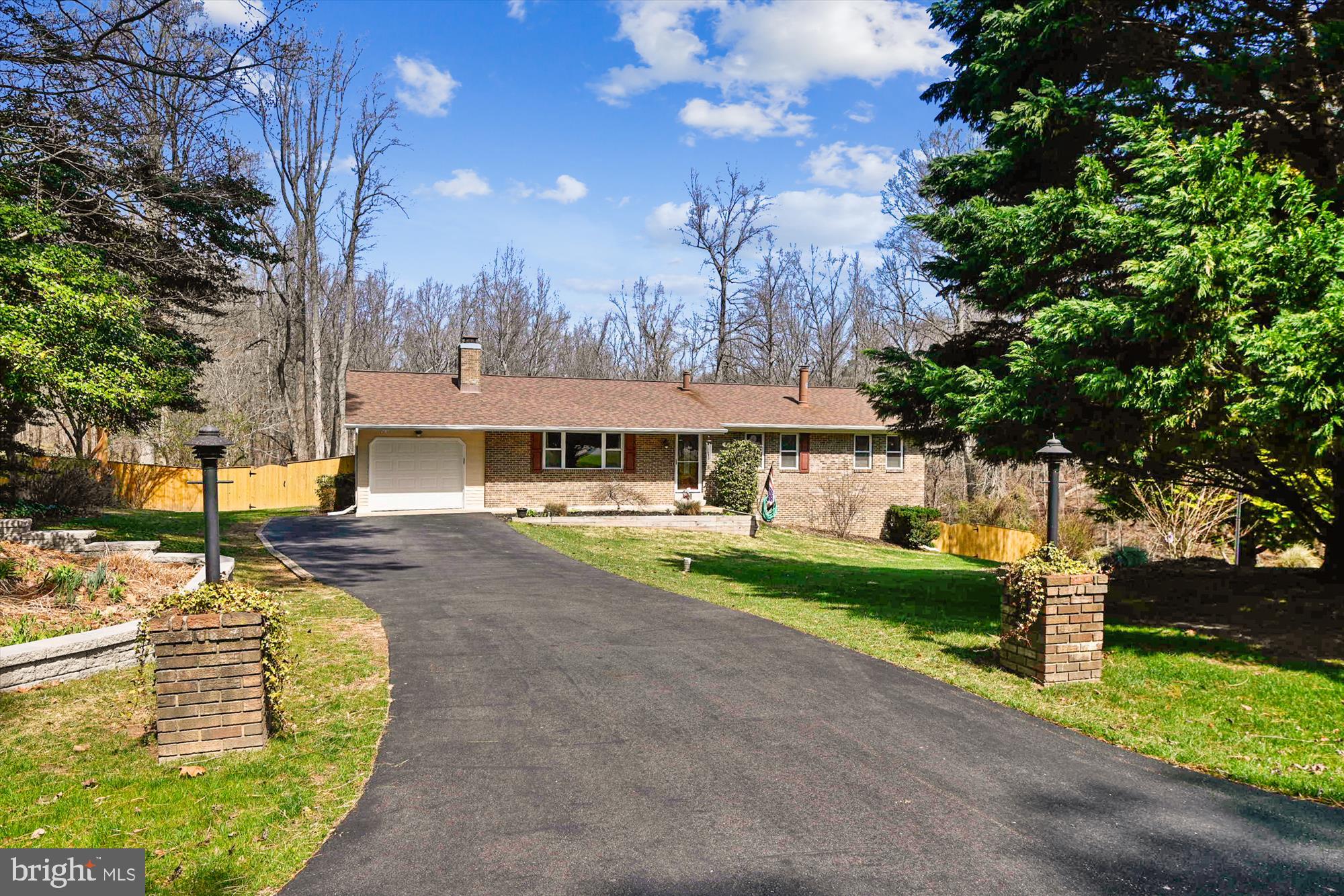 This is the home your clients have been waiting for! Spacious and open home with a huge yard of a little over an acre. Property backs to woods and has recently had a new fence (6 months old) installed with plenty of room to enjoy the yard. Huge utility shed with full electricity to store your lawn equipment. Wood rear fence has a single and double door entrance (for vehicle entry). New retaining wall, garage door, front door, toilets, and kitchen appliances. The home is open, inviting with tons of light pouring in. Enjoy the deck and view with an abundance of wildlife who visit the woods behind you.  Hardwood floors throughout the living room, dining room, and foyer. Laminate flooring in bedrooms. Tile in bathrooms.  Warm cozy fireplace to enjoy on cold winter nights. Large finished basement including a wet bar, half bath, huge utility/workroom and separate office/den area. Large laundry room. Outside entrance. Heating/cooling/ventilation has also been recently added.  Radon mitigation system installed. Driveway has recently been repaved and can handle 5+ cars, plus you have an attached 1 car garage. The rear of the home also has a 30 amp electrical outlet for RV usage.