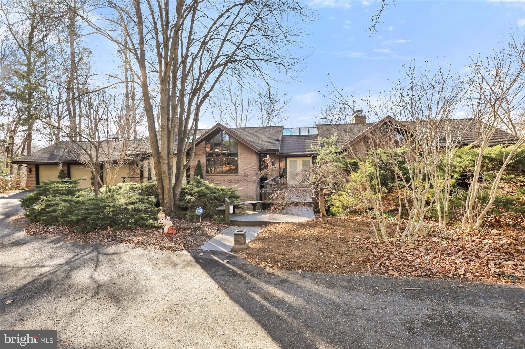 A Private Contemporary Retreat in School Lane Hills
Tucked away on a breathtaking 1.57-acre wooded setting fronting the Little Conestoga Creek, 10 River Drive offers a rare opportunity to experience contemporary architecture thoughtfully integrated with nature in one of Lancaster’s most coveted neighborhoods. Custom-built in 1986, this distinctive home was intentionally designed to blur the line between indoors and out, creating a serene, light-filled environment that evolves beautifully with the seasons.
The rear elevation is truly striking, featuring floor-to-ceiling windows and glass doors that frame sweeping creek views, mature trees, and a colorful native landscape. Whether enjoying autumn foliage, winter snowfall, spring blooms, or summer greenery, the natural setting becomes an ever-changing backdrop to daily living.
Inside, cathedral ceilings throughout the first floor enhance the sense of openness and light, while Venetian plaster accent walls add warmth, texture, and understated elegance. The heart of the home centers around the renovated kitchen and adjacent hearth room, where a gas fireplace creates a welcoming gathering space that flows seamlessly into the great room—ideal for entertaining or quiet evenings at home. The kitchen and primary bath renovations were meticulously executed by the current owners, featuring custom cabinetry, upgraded finishes, and high-quality appliances, reflecting a commitment to both craftsmanship and comfort.
The spacious first-floor primary suite is a true private retreat, offering a sitting room with fireplace, private office, luxurious bath with steam shower, massive walk-in closet, and conveniently located laundry. This thoughtful layout provides exceptional flexibility for one-floor living while maintaining separation from additional living areas.
Additional features include three full baths and two half baths, three to four generously sized bedrooms, and excellent closet and storage space throughout the home. A 3+ car garage provides ample room for vehicles, storage, and hobbies, while separate in-law quarters offer privacy and versatility for guests or extended family.
The lower level presents exciting future potential with space envisioned for an approximately 800-square-foot gym, in-home theater, workshop, artist’s studio, or recreation room, allowing the next owner to further tailor the home to their lifestyle. Energy-efficient gas heat and central air conditioning add to the home’s comfort and long-term value.
Ideally located close to Lancaster Country Day School, Franklin & Marshall College, Wegmans, Stauffers, parks, and Lancaster’s vibrant downtown scene, including the Fulton Theatre, Central Market, acclaimed restaurants, brew pubs, and coffee houses, this property offers both privacy and convenience.
A full suite of pre-listing inspection reports is available, providing confidence and transparency.
Discover a home where architecture, landscape, and lifestyle exist in perfect harmony—schedule your private showing today.