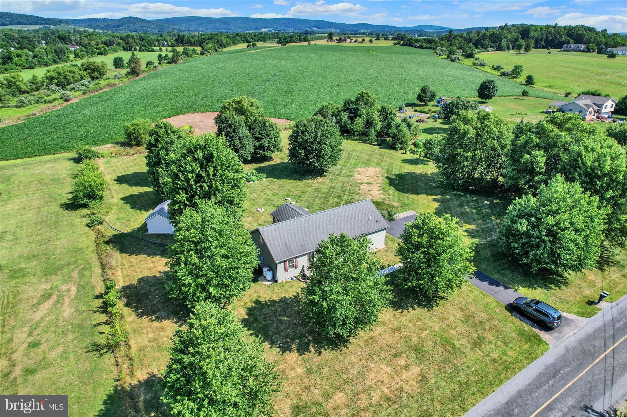Beautifully maintained move-in ready 3 bedroom, 2 full bath, 1572 sqft home built in 2002 on  serene 1.55  rural acre bordering undevelopable farmland in rear.  Enjoy farm and mountain views from the sunroom.  Inside,  the  primary bedroom suite includes on-suite full bath.  Kitchen has all stainless steel appliances.  Full walk-up attic for amazing storage and future finishable space.   Central heating and air conditioning-2019 Trane heat pump with propane back-up as well as whole house humidifier and air scrubber.  2020 new siding, fascia, gutters and all new Pella windows (except sunroom).  12' x 18' shed and 5 raised garden beds can stay.  Sits on 4' crawlspace with Superior Walls, gravel and vapor barrier. Come take a look!