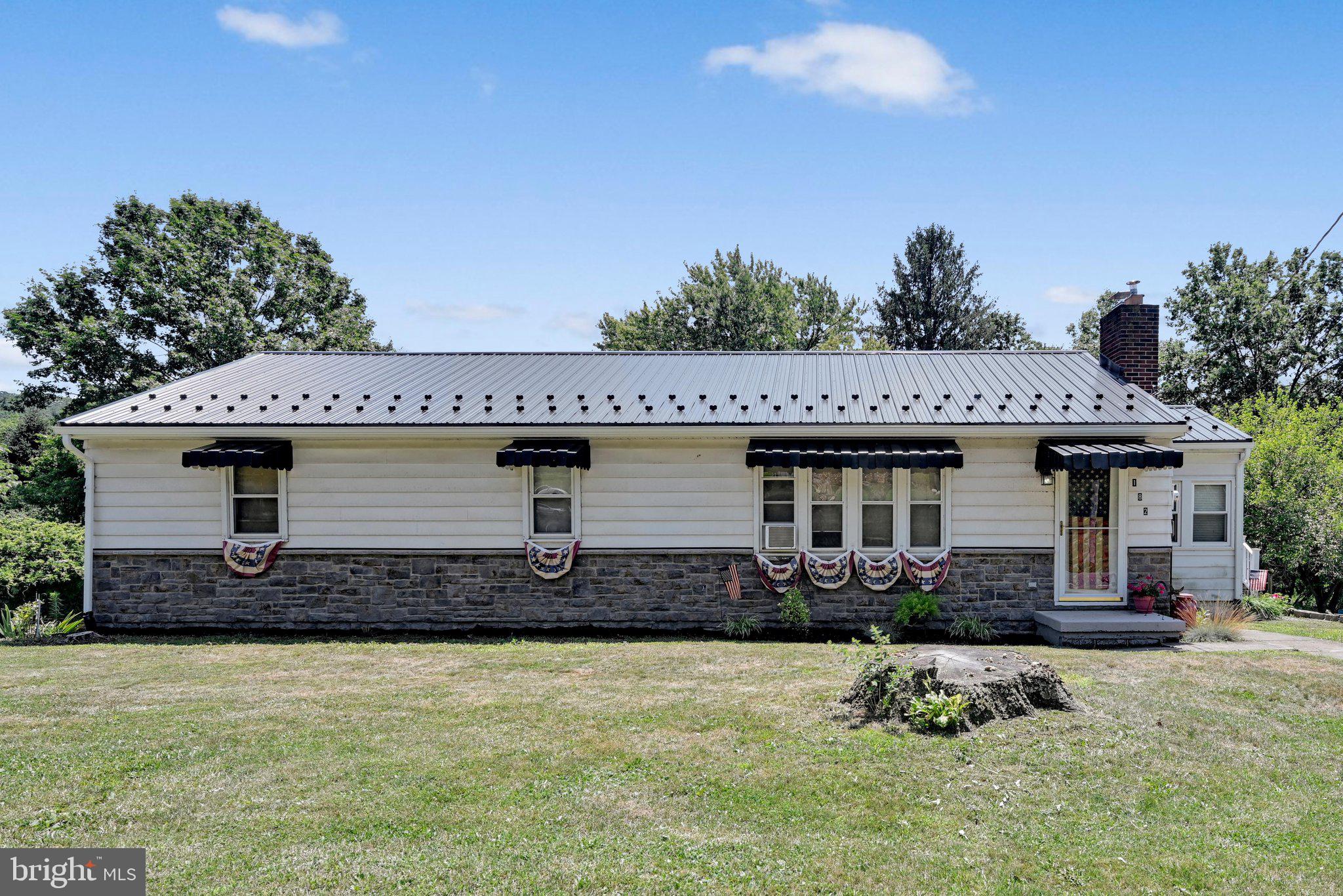 Welcome home to this beautifully maintained ranch nestled on 1.24 picturesque acres, complete with a peaceful stream along the rear of the property and breathtaking mountain and tree-lined views. Whether you're enjoying your morning coffee or winding down in the evening, the spacious deck offers the perfect place to take in the scenery.  Inside, you'll find a open kitchen that flows seamlessly into the living area, creating a warm and inviting space that's perfect for everyday living and entertaining alike.The walkout lower level provides an abundance of additional living space, offering endless possibilities for a family room, home office, gym, or recreation area, with convenient access to the attached two-car garage. Recent updates provide added peace of mind, including a new roof (2025), a complete water system, and a reverse osmosis filtration system. Outside, the expansive yard offers plenty of room for pets, gardening, or hosting family and friends. If you've been searching for a move-in ready home with modern updates, beautiful views, and a tranquil country setting, this one is a must-see!