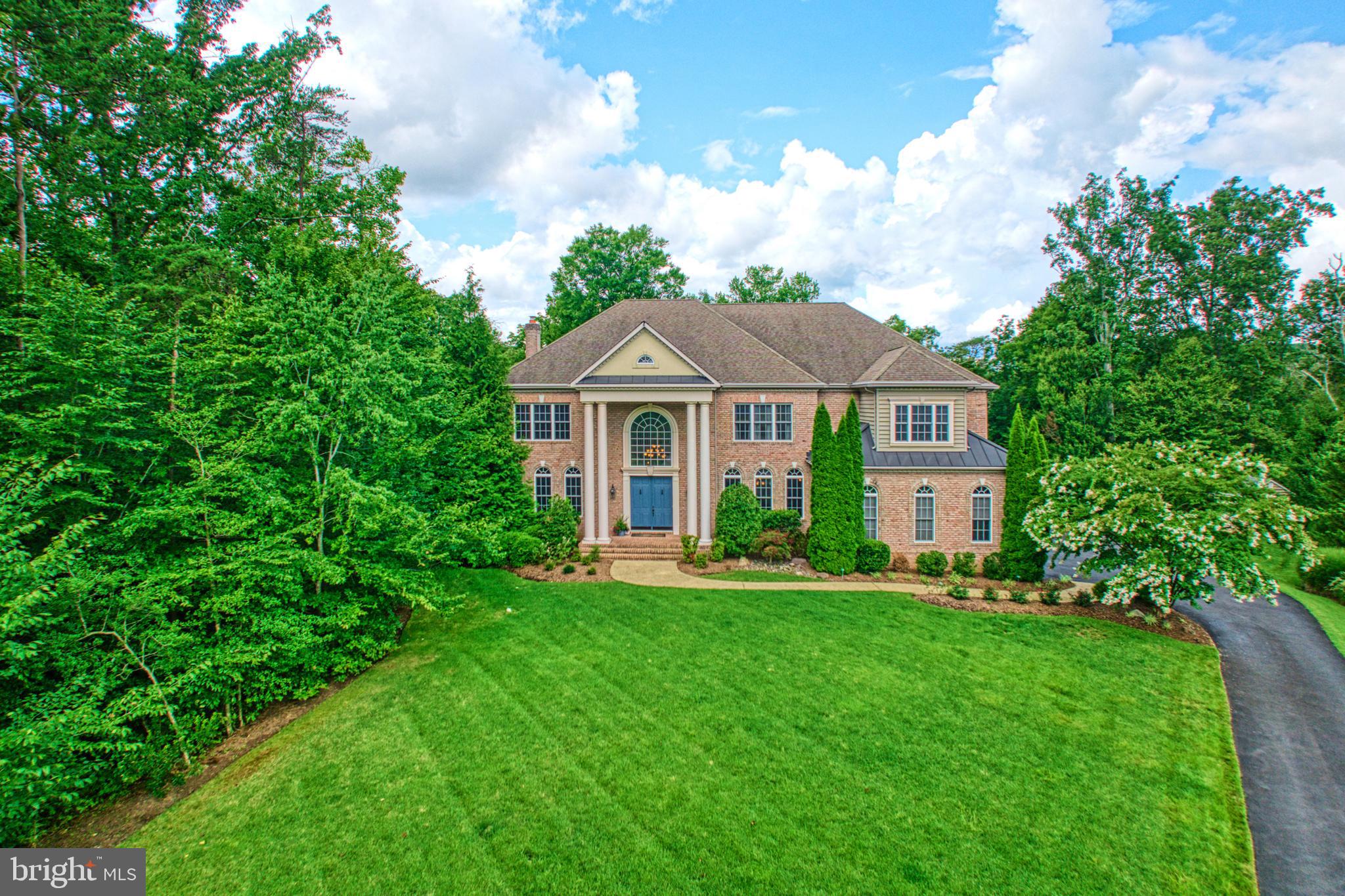 This is the one you have been waiting for! Unbelievably stunning home and setting with many upgrades and renovations throughout.  Sited up on a hill at the end of the street, this manor home has been amazingly cared for by the original owners. The main level is open with a circular flow perfect for daily living and entertaining. The gourmet chefs kitchen has been upgraded with new quartz counters, backsplash, and refinished cabinetry. The major highlights of the kitchen include dual dishwashers, new faucets and sinks, top of the line appliances, and a large kitchen island with ample seating and storage. The main level also features a sunny breakfast room, family room with gas fireplace, renovated home office with built ins (could be another bedroom option), renovated mud room, and private living and dining rooms with butler's pantry. The upper level features a luxurious primary suite including large bedroom with gas fireplace and built ins, sitting room/second office, dressing area with wet bar, spa inspired bathroom, and amazing walk in closet with laundry hookup; three additional bedroom suites with private bathrooms and walk in closets. The lower level is absolutely stunning and has been recently finished with a recreation room, wet bar, game area, top of the line theater, home gym, and a guest bedroom, full bathroom and storage. The list goes on! The outside of this home is equally impressive with a large deck off of the breakfast room with stairs down leading to the award winning design by Colao & Peter Luxury Outdoor Living custom heated pool and oversized spa and pavilion for entertaining. The pavilion is finished with a stone gas fireplace, recessed lighting and ceiling fan. Other upgrades include irrigation system, full house generator, garage parking all on a 1.5 acre lot backing to woods. Located in Davidsonville, but conveniently located just off of Riva Rd and close to commuting routes, short drive to downtown Annapolis, shopping, and restaurants. This one is not to be missed!