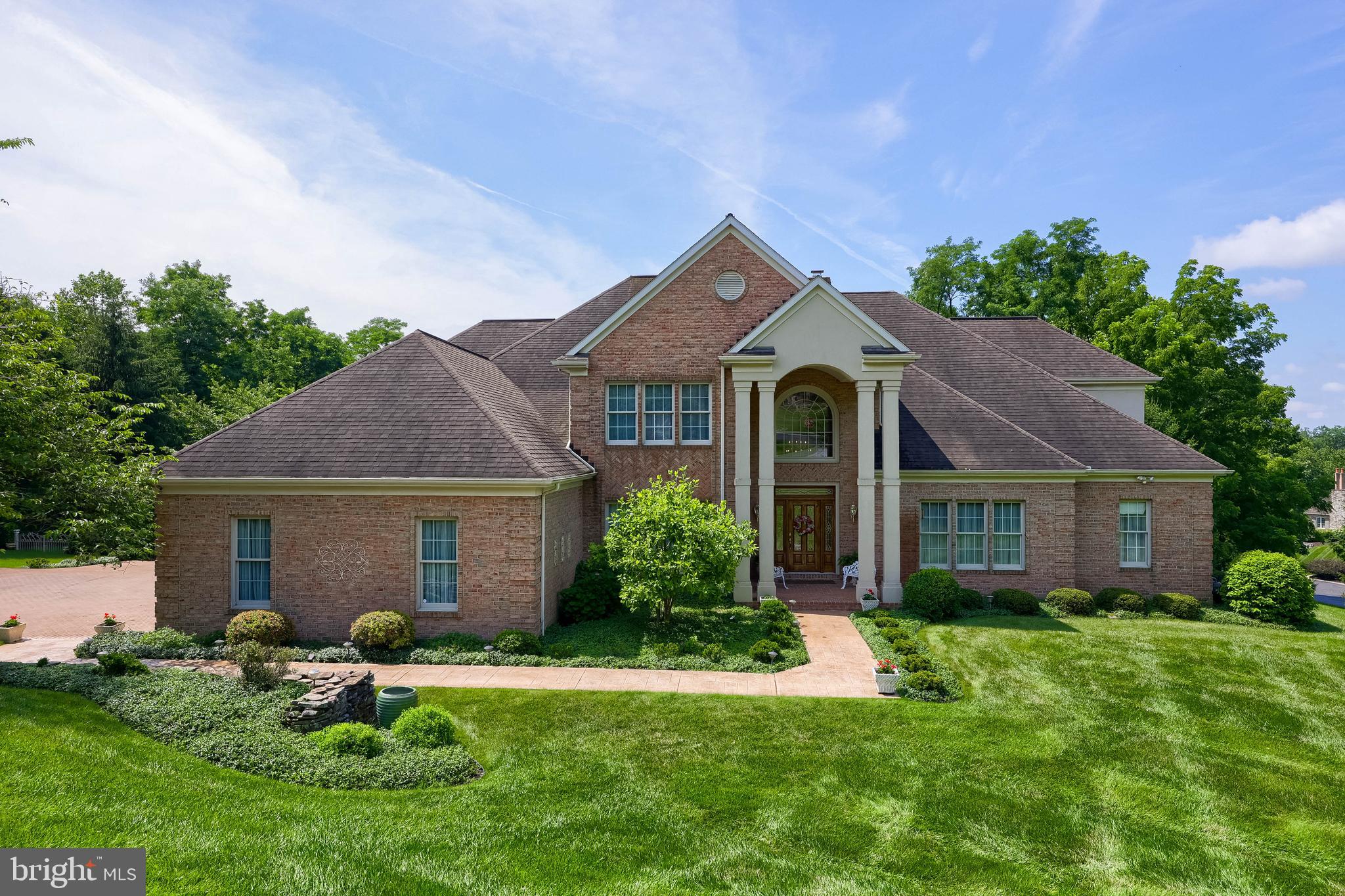 Nestled on a private cul-de-sac just a short distance to golf course and country club amenities in the Wyndham Hills South community,  this extraordinary custom home offers over 7,100 square feet of thoughtfully designed living space. Featuring 4 bedrooms, 3 full baths and 3 half baths, the home combines elegant craftsmanship with everyday comfort.
Designed for effortless first floor living, this home showcases a grand 2 story foyer and a stunning great room with cathedral ceilings, built-in cabinetry, wet bar and fireplace. Abundant natural light pours through Palladian and transom windows, creating a bright and welcoming atmosphere throughout. This level is also highlighted by a spacious primary suite retreat with two walk-in closets, fireplace, dedicated dressing table area, and a luxurious en-suite bath  featuring a walk-in shower, jacuzzi tub, double bowl vanity. There is an additional closet and linen closet. In addition you’ll find a bonus room, perfect for nursery, office, dressing room. 
You’ll find a dedicated office on this level also with rich wood cabinetry built-in. And the formal dining room was designed to accommodate large family gatherings and has a large china closet. 
The chefs kitchen is beautifully appointed with granite countertops, ceramic tile backsplash, newer appliances and ample workspace, flowing seamlessly into a bright, sunny breakfast room. From both the great room and primary suite, step onto the generous patio area, covered and uncovered, overlooking the peaceful backyard setting.  Listen to the soothing waterfall  pond. 
Upstairs and throughout the home you’ll find generously sized living spaces. Guest suite with private bath and two additional bedrooms with Jack and Jill bath.  Storage room with attic access. 
The finished lower level expands the home’s entertainment and recreation options with a large rec room, exercise room,  bathroom, workshop and abundant storage space. 
Outside enjoy the tranquility of a private setting enhanced by a picturesque, peaceful pond with waterfall. An oversized three car garage with convenient basement access completes this exceptional property along with a brick driveway with parking for 5 additional vehicles. All this situated on over an acre lot.  
Offering luxury, space and an unbeatable location this remarkable residence presents a rare opportunity to enjoy resort-style living at home.