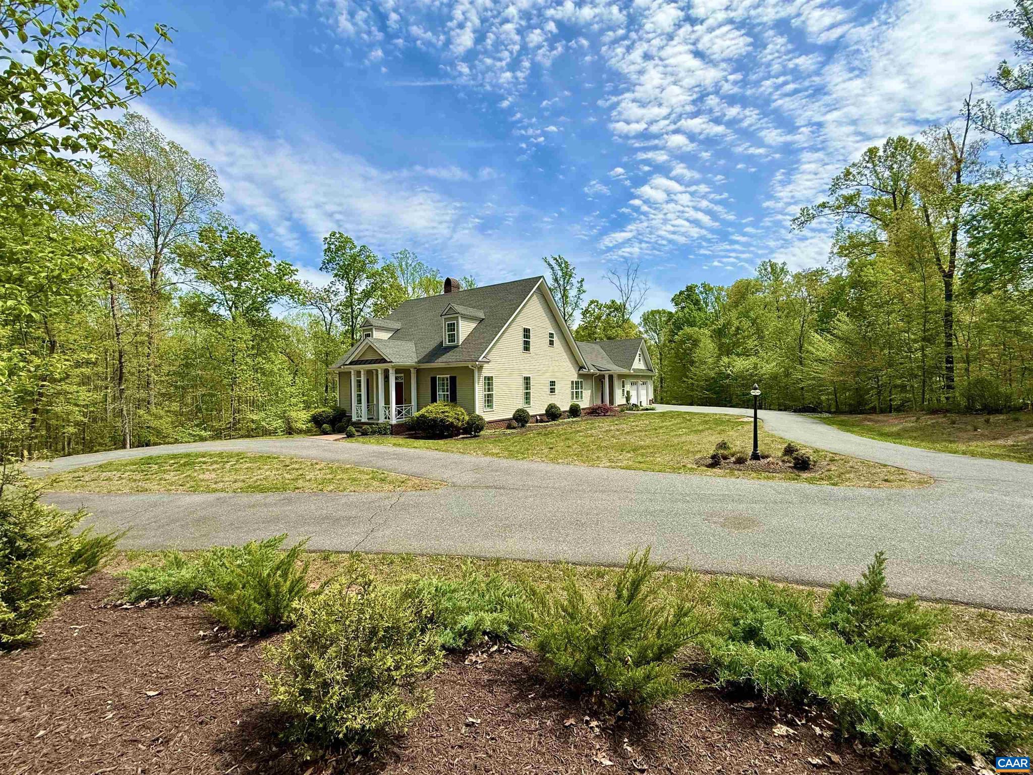 Beautiful Southern Living floor plan custom-built by Southland Homes, located in the desirable equestrian community of Hidden Hills. This exceptional property shows like a model home and offers primarily one-level living with spacious rooms, abundant natural light, and fine custom details throughout. Enjoy exceptional privacy with forested buffer zones on all four sides of the property. The thoughtfully designed first floor layout includes a primary suite, plus a guest suite or home office, formal and informal living spaces, and a well-appointed kitchen featuring an eat-in breakfast room and wet bar ideal for both everyday living and entertaining. A cozy brick fireplace with a Vermont Castings wood stove adds warmth and timeless charm. Additional highlights include a versatile bonus room perfect for a gym, recreation space, or office, along with a 2-zone HVAC system for enhanced comfort and efficiency. The oversized two-car garage includes a third bay ideal for an ATV, golf cart, or riding mower. A huge walk-out basement with full bath rough-in offers endless expansion potential. Enjoy the community?s miles of wooded trails and a riding ring, perfect for outdoor recreation. Additional 4.79acres next door is available for sale too.,Granite Counter,Wood Cabinets,Fireplace in Family Room