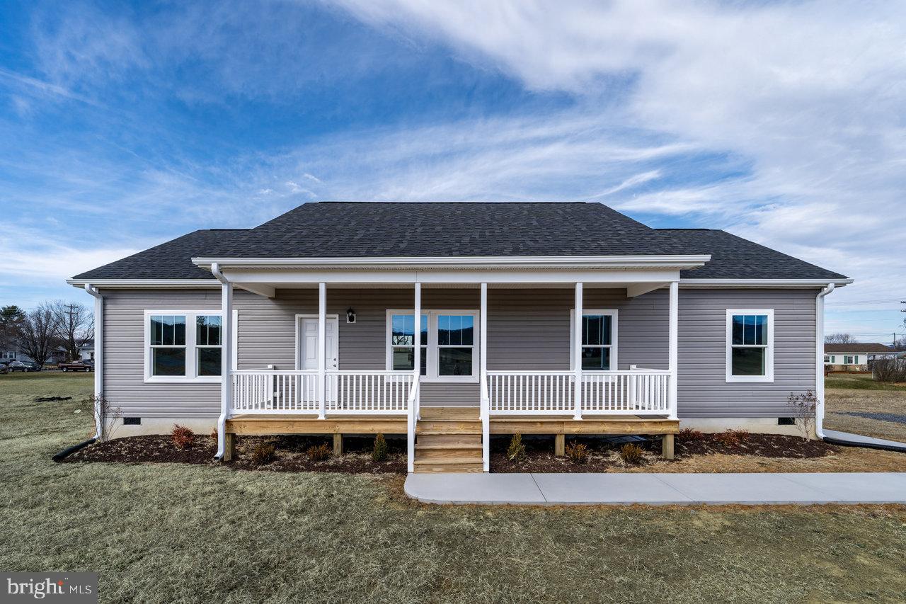 Welcome to this brand-new home nestled on a serene half-acre lot in the heart of Stanley, Virginia, with exceptional mountain views and in-town convenience. This 3-bedroom, 2-bathroom home is served by town water and sewer and is truly move-in ready, with just over 1500 square feet of space for living and entertaining.  As you enter the home you will find a bright, open-concept living space with modern finishes throughout. The upgraded kitchen is the real standout, featuring a large granite island, sleek stainless-steel appliances, and an eye-catching mosaic tile backsplash. The primary suite offers a spacious retreat with an expansive walk-in closet and an impressive bathroom, complete with a luxurious tile shower that is a must-see. Additional bedrooms are well-sized, ensuring comfort and functionality for all to enjoy. The laundry room, which is conveniently located at the side entrance to the home, is designed with practicality in mind. It features full-size washer and dryer, matching countertops and tile backsplash to complement the kitchen and offers plenty of cabinet storage for all your organizational needs. Do not miss the opportunity to make this beautiful home yours today, with its perfect blend of modern amenities and peaceful location.