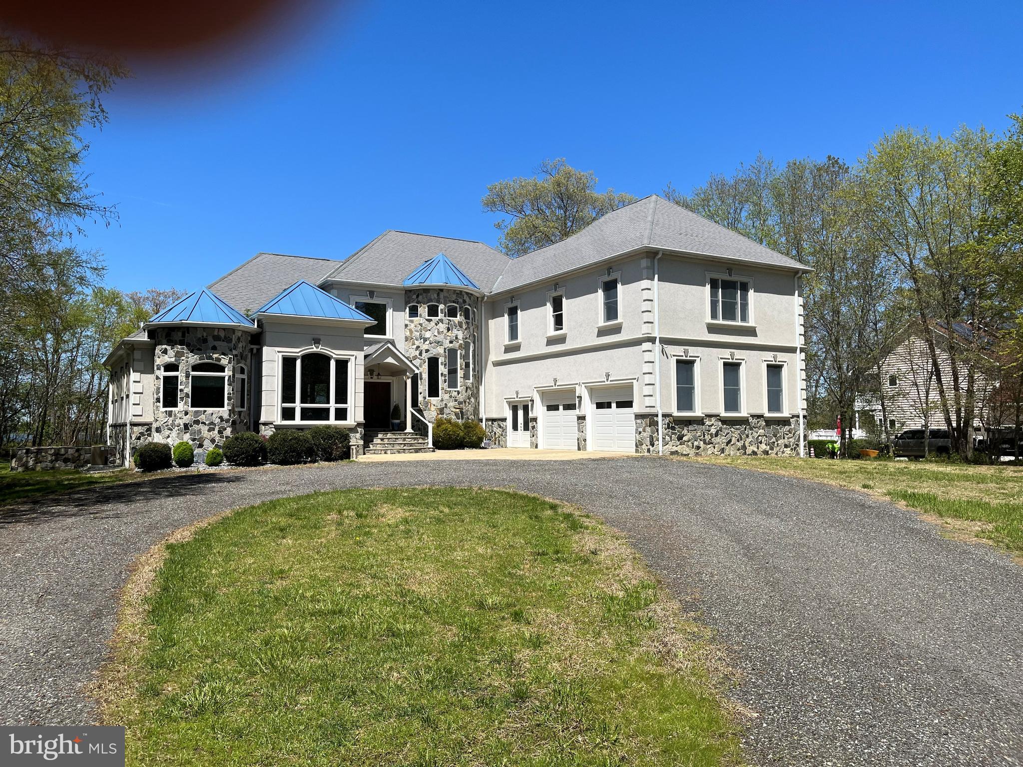 Stunning Custom-Built Waterfront Home situated on Breton Bay in Leonardtown. The views alone make this property a showstopper! There are so many attributes that make this home impressive, you will need to tour it in person to see the quality and craftsmanship throughout.  Main Floor Features: Welcoming wooden double doors greet you as you enter the splendidly spacious open floor plan; Striking 3” Tigerwood hardwood throughout mail level; Office space with chair railing and custom trey ceiling; Master suite, customized trey ceiling, 2 walk in closets with custom shelving and automatic lighting, lovely water view and door to patio; Master bathroom with double vanities, large stand up tile shower includes multiple shower heads, soaking tub with air dryer, tile floor; 2nd bathroom with custom sink and shower includes separate  door leading out to patio; Living room with water view, stone gas fireplace, beautifully handcrafted custom built ceiling and entertainment center; Dining room with water view, chair railing and custom trey ceiling; Gourmet Kitchen with water view, slate tile, upgraded countertops, built in microwave, abundance of custom cabinetry, gas stove with warmer for chef’s delight, large center island, cabinets all around, sitting area/table space; Huge mud room with slate floors; Laundry room, with laundry shoot from 2nd floor, slate tile, cabinet for storage, wash sink, extra-long counter for folding; 2-story foyer with wainscoting; Fully screened in back porch with slate tile. 2nd Floor Features: Wooden curved staircase, with custom handrail, Tigerwood floor in hallway; 2nd level master suite, 2 closets with custom shelving, huge sitting area, and separate desk area over garage; 3rd bedroom with water view and  door to outside deck with 14x6 closet with custom shelving; 4th bedroom with water view and sitting area, French door to outside deck, custom 14x6 closet; Bathroom with tile, 2 vanities, jetted tub, standing shower and extra storage. Basement Floor Features: Extra-large fully outfitted bathroom, with a tub/shower and sink; Bar area with sink and outlets for appliances; Full theater room with screen; Large area for gaming tables; 5th Bedroom with sitting area; Office space or room for home schooling, 5x11 custom closet with shelving; Plenty of storage for all your needs; Double exit doors to lead outside on both sides of home.  Throughout the home there is 1x7 custom baseboard door trim,  Anderson doors and windows. A whole house sound system for your enjoyment.  Oversized attached 2 car garage, double door entrance, with generator, and ample storage space. Additional detached 2 car garage with finished office space/loft above.  Stone and concrete circular driveway provide ample parking.  Screened-in porch and patio area provide a wonderful and relaxing entertaining area.  All your need to do is sit back with a cold beverage and enjoy your very own waterfront oasis! Estimated 120ft rip rap on shoreline.  To make this truly waterfront living, it includes approximately160 ft of pier, the perfect spot for sunning, crabbing, fishing, and boating.  The possibilities are endless!!