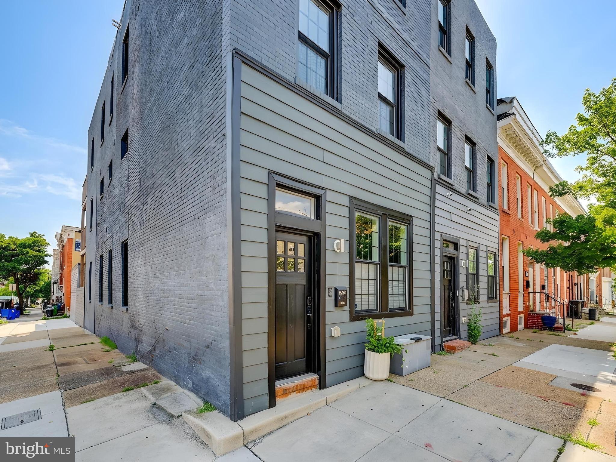 This large beautifully renovated end-unit home with detached oversized garage sits right on the dividing line of the Butchers Hill and Middle East neighborhoods, just a few short blocks from the Johns Hopkins Medical campus and School of Public Health. This home was renovated in approximately 2019 and has a fantastic open layout, high ceilings (with gorgeous tray ceiling detail on the entire main level), recessed lighting, and uniform flooring throughout. The layout is open and spacious . The main level has a living area, dining area, gourmet kitchen, and powder room and opens to an enclosed backyard, which then enters into a large one-car garage. The second level has two spacious bedrooms each with en-suite full bathrooms,  and hallway laundry access as well as neutral access to a rear balcony. The third floor has a large primary suite with walk-in closet, large primary bath with soaking tub, double vanity and separate shower, as well as a family room and access to another balcony. This home is one block from La Barrita, an amazing neighborhood restaurant, one block from an award winning, brand new pre-k-8 neighborhood school, and an easy walk Ministry of Brewing, Water for Chocolate, and Patterson Park, among other places. A new cafe and bottle shop (Jem's at 2200) is expected to open soon a block away.