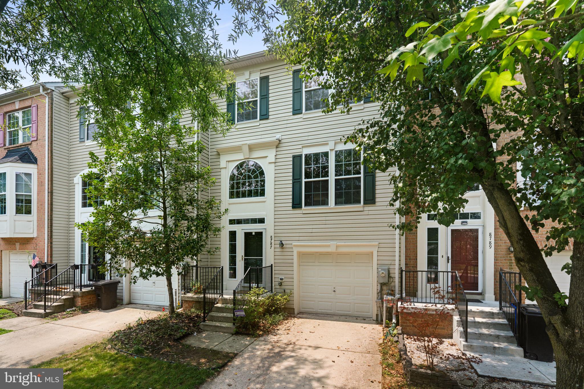 Beautifully refreshed Colonial-style, three-level townhouse residence offering 3 bedrooms, 2 full bathrooms, 2 half bathrooms, 2,598 finished square feet, and a 1-car attached garage in desirable Daniel’s Mill Overlook. Extensively refreshed in 2026, this home features fresh paint throughout the walls, ceilings, trim, and doors, drywall repairs, updated lighting, electrical cover plates added, and updated smoke/carbon monoxide detectors. Additional major updates include a water heater (2023), roof (2019), and HVAC system (2015), offering added peace of mind. // Step inside the impressive two-story foyer, where hardwood flooring and a newly updated light fixture create a welcoming first impression. Upstairs, the main level opens to a formal living room with luxury vinyl tile flooring and a conveniently located powder room featuring a newly installed vanity light. Continue into the spacious, open-concept family room, highlighted by hardwood floors, a cozy gas fireplace, and a decorative wall niche above the mantel that adds architectural interest. // Tastefully updated in 2026, the gourmet eat-in kitchen seamlessly connects to the family room, making it ideal for both everyday living and entertaining. Features include hardwood flooring, granite countertops, freshly painted cabinetry, a center island with breakfast bar seating, a pantry, and stainless steel appliances, including a refrigerator (2020), dishwasher (2020), range (2019), and microwave (2024). The bright breakfast area is nestled within a charming bump-out and provides direct access to the updated, newly reconstructed, and pressure-treated deck featuring updated framing, joists, posts, boards, hangers, and safety railings. // The upper level offers three hardwood-floor bedrooms and two full bathrooms. The spacious owner’s suite features vaulted ceilings, a relaxing sitting area, a walk-in closet, and a private ensuite bath. Newly updated in 2026, the ensuite showcases luxury vinyl plank flooring, recessed lighting, and a glass shower door, along with a corner soaking tub, separate shower, private water closet, and dual-sink vanity. The secondary full bathroom has also been refreshed, and one of the secondary bedrooms includes its own walk-in closet. // The fully finished lower level provides exceptional flexibility with a spacious recreation room featuring newly installed plush carpeting and updated lighting. This level also includes a laundry closet with a washer and dryer replaced in 2020, a half bathroom, interior access to the garage, and a versatile fourth bedroom that can also serve as a home office or den. This room also features newly installed carpeting and walk-out access to the covered patio and backyard backing to a school. A separate mechanical room provides additional storage and utility space.