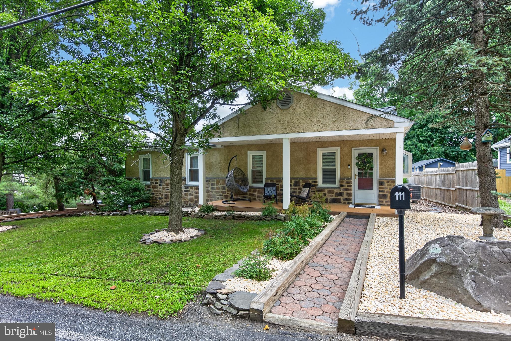 Move-in ready and offering the privacy of a single-family home at a price point comparable to many townhomes! Welcome to 111 Fulmer Road, a well-maintained two-bedroom home situated on .46 acre in Lower Frederick Township and the Perkiomen Valley School District. Public records indicate 920 square feet; however, the finished lower-level family room does not appear to be included in that figure and provides valuable additional living space.
The covered front porch opens into a bright living and dining room combination with hardwood floors. The kitchen features oak cabinetry, tile flooring, stainless-steel appliances and a comfortable breakfast nook. Sliding doors lead to the large rear deck, creating an easy flow for outdoor dining, entertaining or simply relaxing. A convenient laundry room is located just off the kitchen.

The main level also includes two bedrooms and a full bathroom. The larger bedroom is currently being used as a shared children’s room. The finished lower level offers additional living space, along with unfinished storage and utility areas.
Outside, enjoy a spacious backyard, plenty of off-street parking and room to enjoy the outdoors. Additional highlights include public water and sewer, central air, a heat pump installed in 2018, a new roof installed in January 2025 and new stucco on the chimney completed in August 2024.
Located just minutes from Spring Mountain Adventures, the Perkiomen Trail, Green Lane Park and other nearby parks and trails, with convenient access to Skippack Village, Routes 29 and 73 and major commuting routes. A move-in ready single home with outdoor space, important updates and a convenient location—come see all that 111 Fulmer Road has to offer!