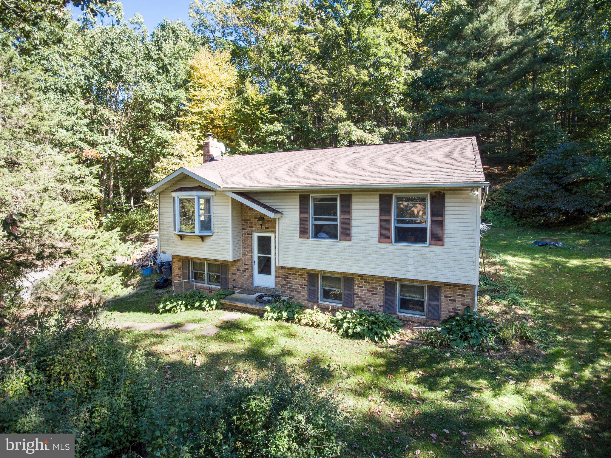 Welcome to your own private retreat! Nestled on 1.67 wooded acres, this charming split foyer offers the perfect blend of nature, comfort, and functionality. Surrounded by mature trees and peaceful scenery, this 2 bedroom home is ideal for those seeking privacy and outdoor living. Relax or entertain on the spacious 16x16 deck complete with a brick BBQ area, perfect for enjoying cool evenings and scenic views year-round.
Inside, you'll find updated vinyl plank flooring throughout much of the upper level, an eat-in kitchen with skylight, painted cabinetry with updated hardware, and multiple newer windows that bring in natural light. Cozy up by not one, but TWO wood stoves with rough-in available for an additional pellet/wood stove on the upper level.
The fully finished walk-out lower level provides additional living space perfect for a family room, recreation area, home office, or guest space and includes a full bathroom. Additional features include central air, heat pump, newer slider doors to the deck, bay window, and a wooded setting that truly feels like a getaway while still being conveniently located.
If you’ve been dreaming of a peaceful property with character, privacy, and room to make it your own, this nature lover’s paradise is ready to welcome you home!