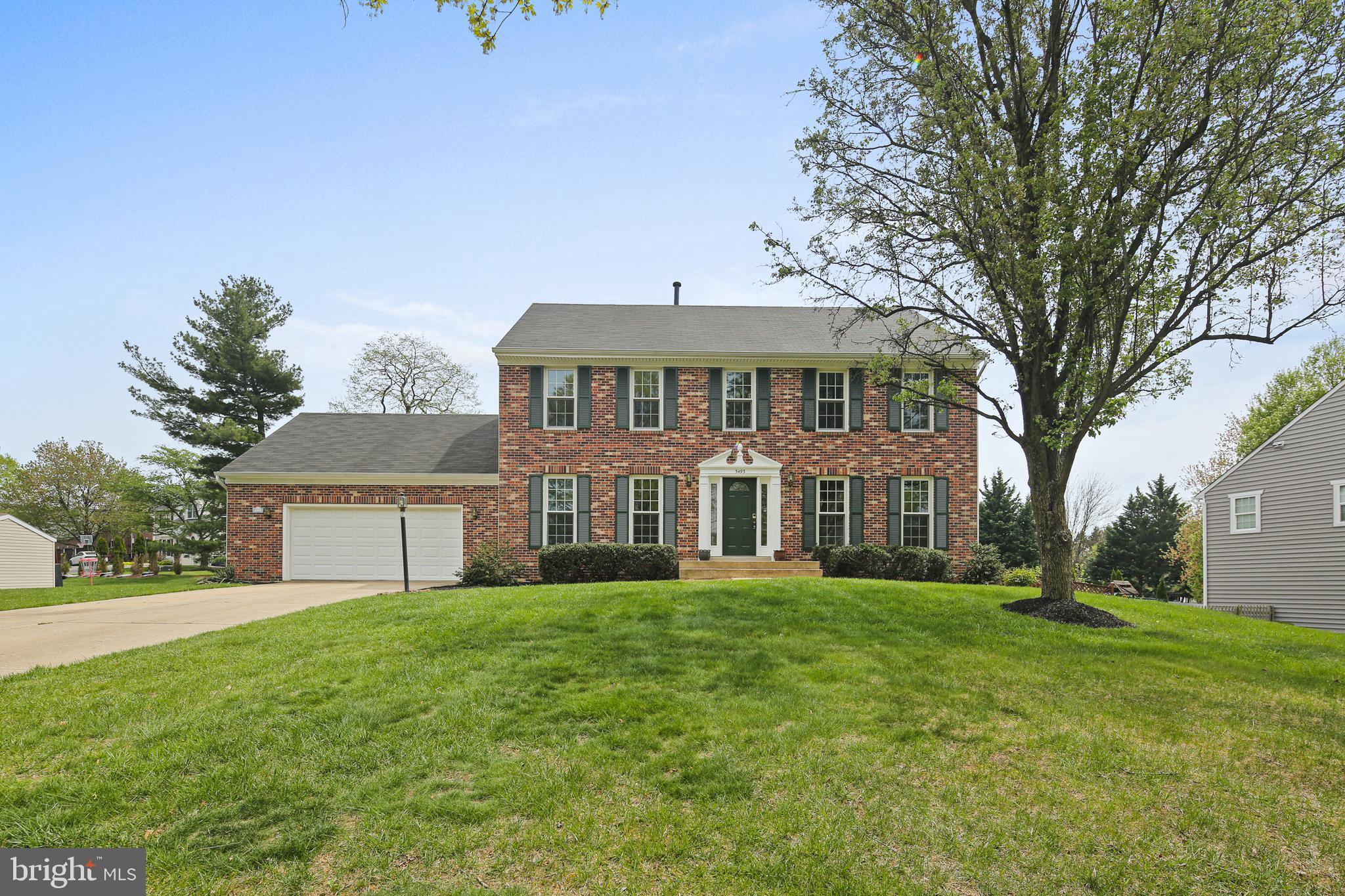 This gorgeous colonial offers the perfect balance of comfort and updates—plus a two-car garage to make rainy or snowy days a breeze. Head inside through the laundry room or follow the walkway to the front door and into a bright, welcoming main level. Stunning hardwood floors (new in 2025!) flow from the dining room to the living room, and French doors open to a cozy family room with a brick-surround fireplace and access to the backyard patio. The remodeled kitchen (2021) ties everything together with stylish black appliances, upgraded counters, a custom tile backsplash, and a sunny breakfast area that connects to the family room. Upstairs, you’ll find five generously sized bedrooms, all with great closet space and fresh carpet (also 2025). The roomy owner’s suite feels like a retreat with a cathedral ceiling, ceiling fan, and a spa-inspired ensuite bath featuring a soaking tub with custom surround, double vanity, and updated tilework. A second full bath in the hall serves the additional bedrooms. The finished lower level is ready for fun—whether it's movie marathons, game nights, or just a little extra space to spread out. There's also a full bath and unfinished storage space for your seasonal gear or hobby supplies, plus a walk-up to the backyard that makes outdoor access easy. With over $120K in thoughtful upgrades, this home is move-in ready and waiting for its next chapter. Welcome home!
