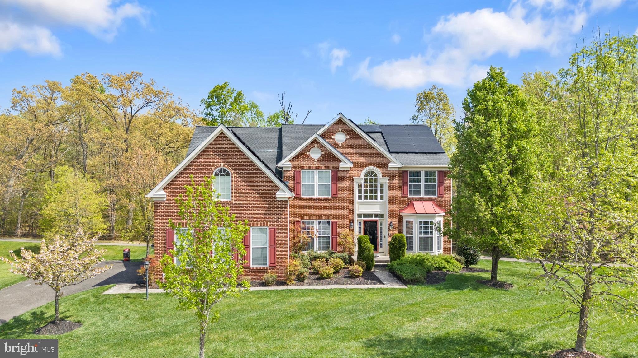 Welcome to this beautifully maintained brick-front Colonial in the sought-after Woodburn Estates subdivision, offering space, comfort, and a layout designed for both everyday living and entertaining. Set on over half an acre and a total of 6118sqft, this home makes a strong first impression with its classic curb appeal, manicured lawn, expansive driveway leading to a side-entry three-car garage, and 6 rooftop solar panel systems (included with purchase). Step inside to a bright and inviting interior featuring hardwood floors, abundant natural light, and a thoughtful flow between formal and casual living spaces. This home is equipped with a water treatment system and an entire home surround sound system, delivering seamless, high-quality audio throughout ideal for both everyday living and entertaining. 


The main level offers a seamless blend of functionality and style, including a mudroom/laundry, formal living room, spacious dining room, and an office/bedroom—perfect for working from home. The open-concept kitchen is the heart of the home, complete with generous cabinetry, spacious walk-in pantry, granite countertops, a center island, and a breakfast area that opens to the family room with a cozy fireplace. Just off the kitchen, a light-filled sunroom with beautiful skylights provides the perfect space to relax, unwind, or enjoy morning coffee with views of the backyard. 


Upstairs, you’ll find a well-appointed layout with four spacious bedrooms and three full bathrooms, including a large primary suite with a sitting area, two walk-in closets, and a private en-suite bath designed for comfort and relaxation. Two of the secondary bedrooms are connected by a convenient Jack and Jill bathroom, offering both privacy and functionality and the fourth bedroom with a private en-suite bathroom. 



The fully finished walk-out basement expands your living space even further, featuring a large recreation area with another fireplace creating a warm and inviting space for entertaining guests, a beautiful built-in 6 chair bar with granite countertops, a fully functional insulated home theater with private surround sound, and a full bathroom. Enjoy outdoor living on the expansive rear deck overlooking a private, tree-lined backyard and a walk out patio with a sitting wall—perfect for gatherings, relaxing evenings, or simply enjoying the peaceful surroundings.  The home also features a yard sprinkler system, making it easy to maintain the beautifully landscaped grounds.  It offers not just space—but a lifestyle of comfort, convenience, and connection.



Located in the Woodburn Estates subdivision, the neighborhood offers a peaceful setting with a running trail for outdoor enjoyment and a playground area for little ones, while still being conveniently close to major commuter routes, shopping, dining, and everyday essentials.