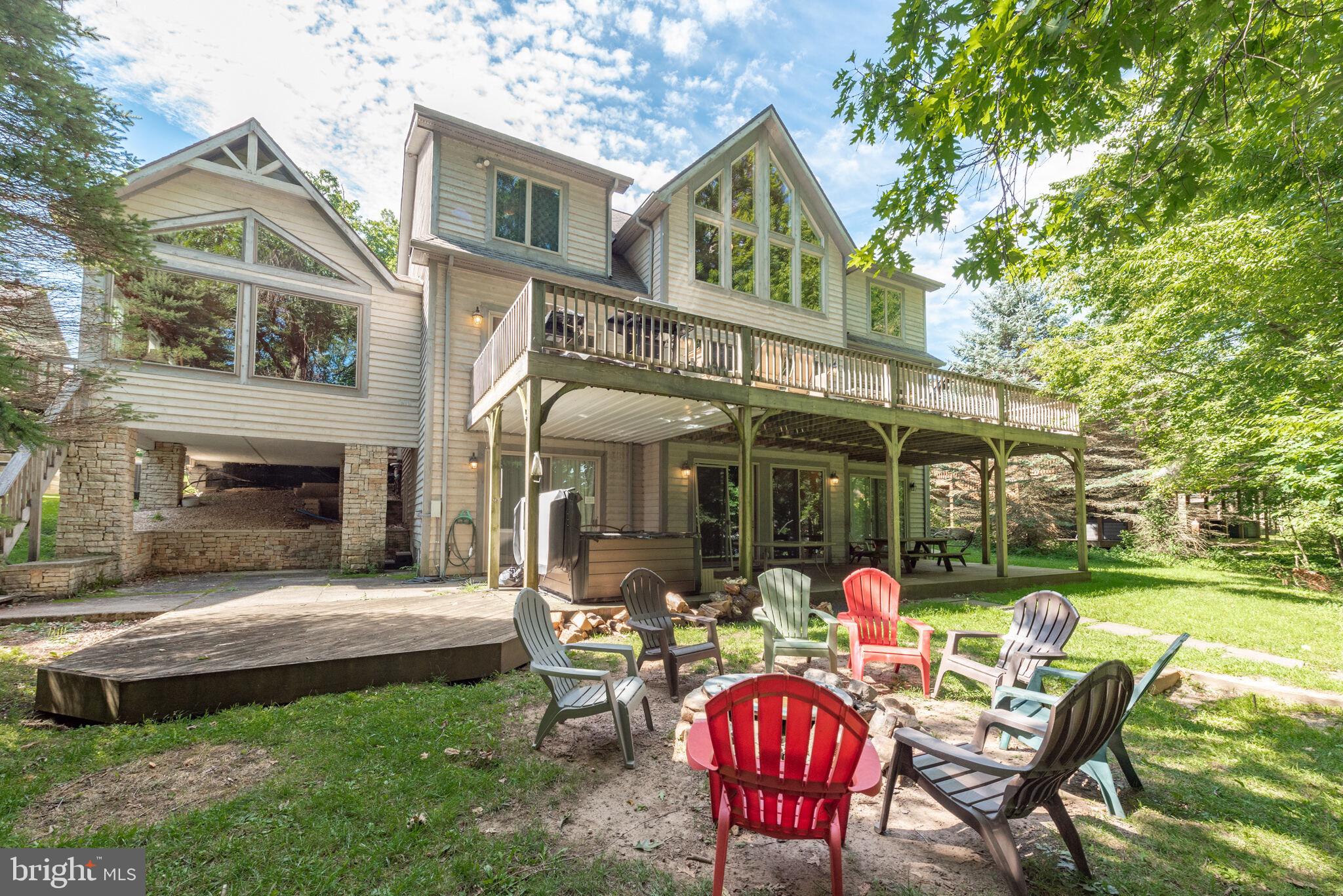 Lakefront vacation home with a private indoor pool, 8 bedrooms, and 6.5 baths! This 3-level mountain retreat is one of the long-time, highest performing rental homes ever at Deep Creek Lake with past gross rents totaling between $256,900 - $191,145!! Featuring a brand new roof with 50 year warranty, new windows in the pool room,  and recent upgrades to the kitchen, living room, and dining area. Professionally decorated throughout, this home also features an abundance of windows, 3 of the 8 bedrooms are suites with their own private bathrooms, 2 dishwashers, and 3 refrigerators for those large gatherings. Take the in the expansive views of Deep Creek from the private, unrestricted Type A boat dock eligible for 2 power boats and 1 personal watercraft with 100 feet of lake frontage and a gentle slope from the house. Centrally located to all restaurants, marinas, shops, and the Deep Creek Lake state park, this home is situated on an oversized 1.3 acre lot. In addition to the indoor swimming pool, this home has all the 'fun' features for your family and friends to enjoy and make memories at Deep Creek including a large game room, hot tub, outdoor fire pit, 3 fireplaces, and oversized lake side deck! Don't miss this opportunity to purchase one of few lakefront rental homes with its own indoor pool and private boat dock! Owners will consider seller financing!