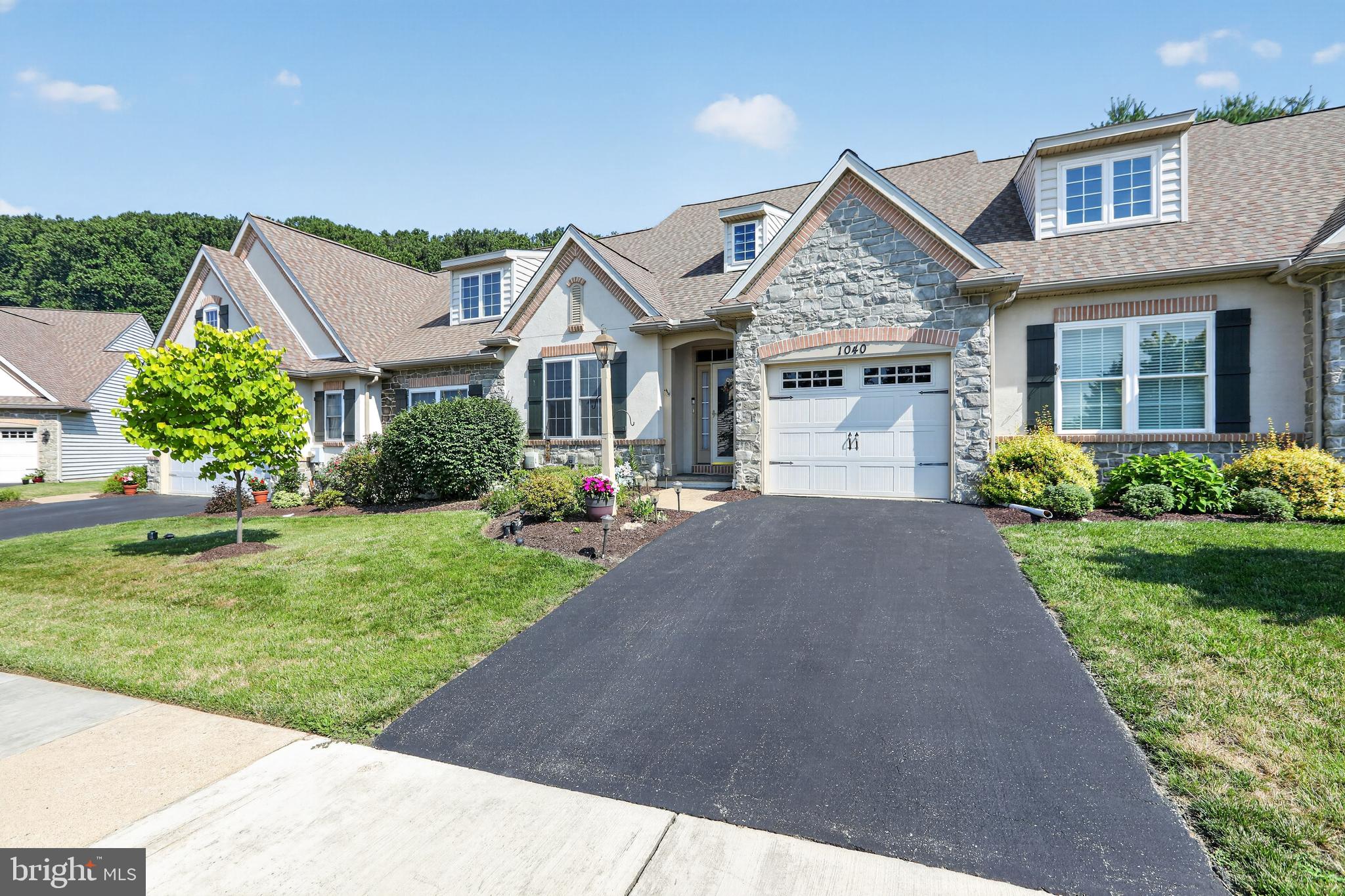 Privately located carriage home in the sought after 55+ community of The Woods At Rock Raymond,  Features include Entry Foyer with  vaulted ceiling and hardwood floor, Living Room with crown molding, Family Room with ceiling fan and stone gas fireplace, Kitchen with counter seating, built in micro, range, dishwasher and refrigerator, spacious pantry closet and recessed lights, Dining Area with wainscoting, Sun Room with ceramic tile floor and outside entrance to the patio in a very private setting,  Powder Room and one car garage complete the first floor.  The upper level loft is perfect for an office or tv area, double doors lead to the Primary Suite with an oversized bedroom with crown molding and ceiling fan, the primary bath features a double bowl vanity, soaking tub and stall shower and a huge walk in closet, guest bedroom, hall bath with laundry closet complete the upper level.  Full Basement, ready to finish. The home has been lovingly cared for by the original owner, new roof, newer HVAC system,  Great location near shopping, golf, access to major roadways, just a short drive to Exton, quick possession possible, neutral decor, easy to show.  Schedule your appointment today