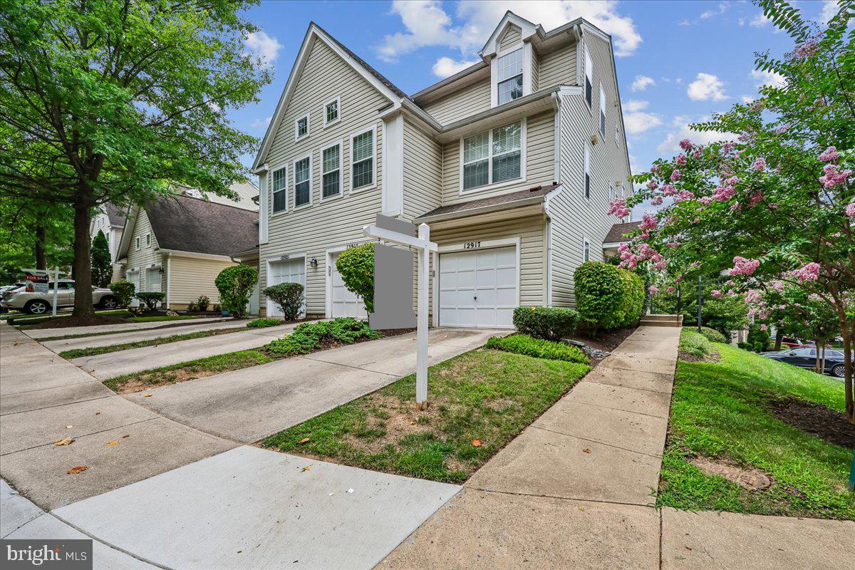 Welcome to 12917 Bridger Dr, a beautifully updated end-unit contemporary townhouse in the sought-after Cloverleaf Center community! Offering 2 spacious bedrooms, 2 full bathrooms and one-half bathroom, private balcony, and a built-in one-car garage with an electric vehicle charging plug designed for modern living. This light-filled home features an open floor plan with soaring vaulted ceilings, fresh paint, new carpet, and abundant natural light throughout with the oversized windows.  The kitchen is a chef's delight with beautiful granite counters, stainless appliances, pantry and additional cabinets that provide flexibility since they are not attached to the wall.  This low-maintenance community includes snow removal, trash service, and common area maintenance. Ideally located just minutes from I-270, Route 355, and quick access to Wegmans, Target, Home Depot, Clarksburg Premium Outlets, Topgolf, Milestone Shopping Center, dining, and entertainment. Move-in ready and perfectly situated—don't miss this exceptional opportunity!