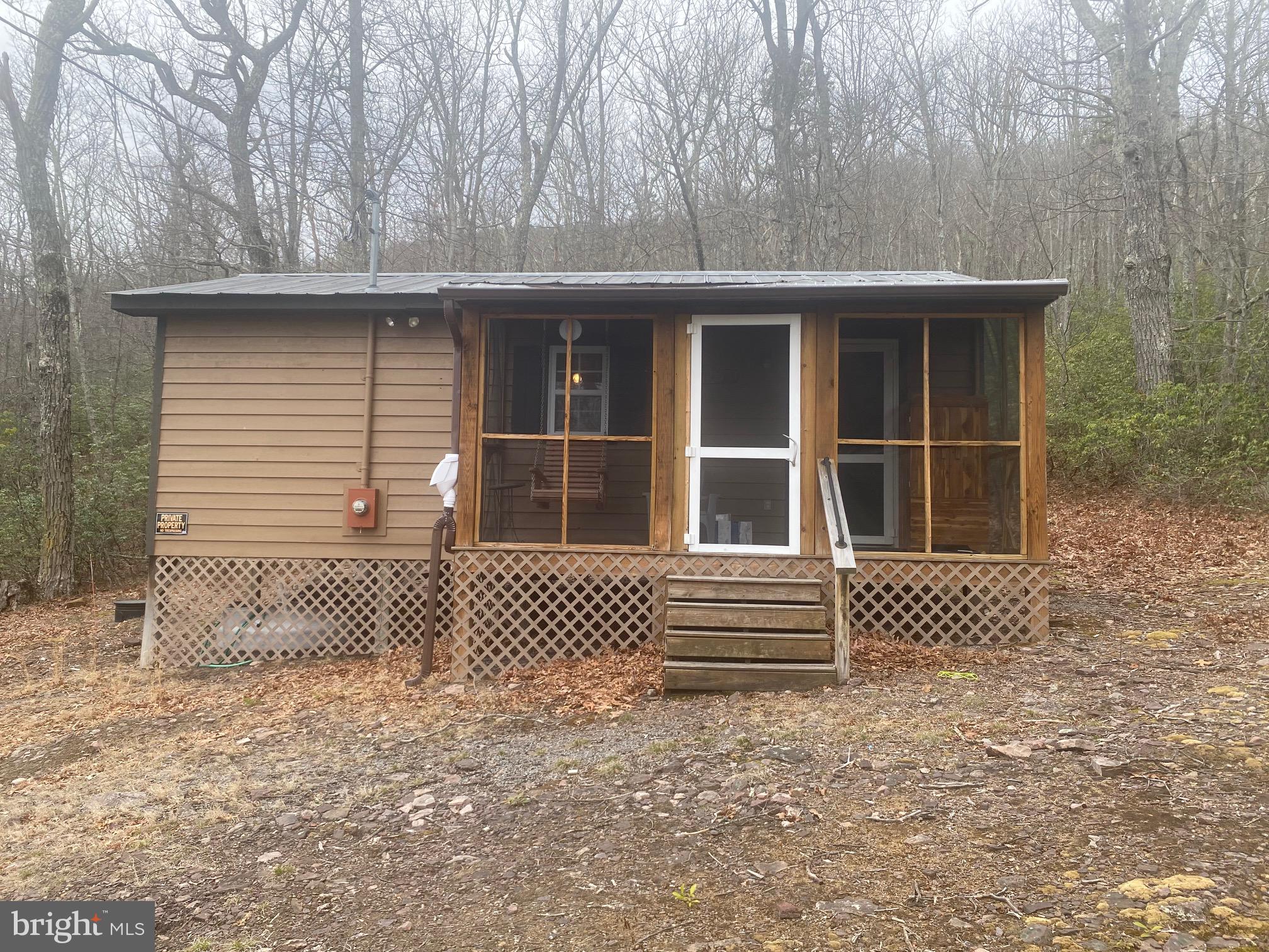 Charming 1 Bed, 1 Bath cabin located near Monongahela National Forest. Cabin sits on 15.17 acres in North Fork Flats and would be perfect for hunters, fisherman or any kind of outdoor enthusiast!  New refrigerator, New Commode, New flooring throughout, New Gutters and New furniture. Screened in porch is great for enjoying those warm summer evenings. Cistern and septic (septic unapproved).  Only 25 minutes to Seneca Rocks Recreational area.
