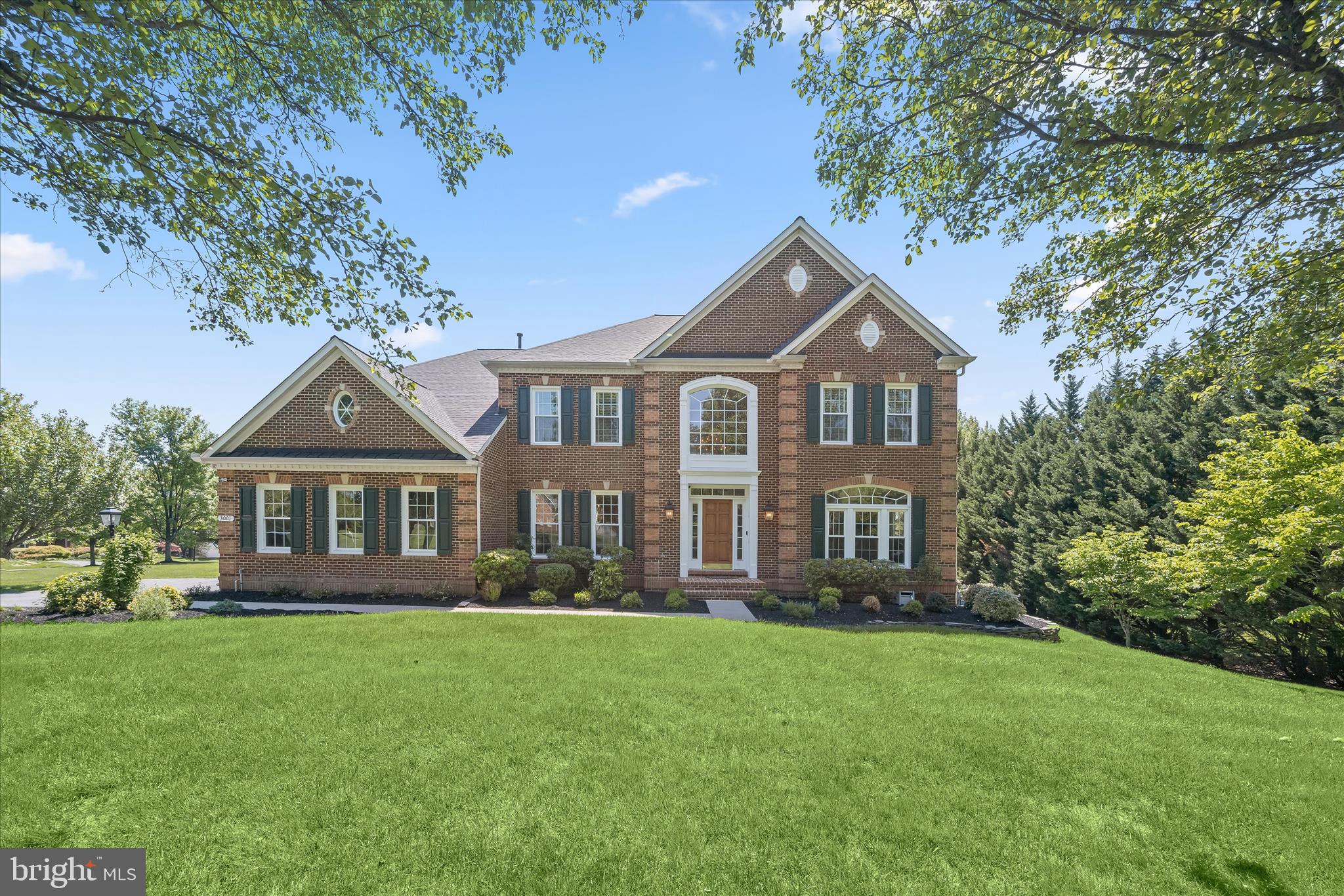 Nestled on a premier corner lot in the sought-after Brantwood community of Ellicott City, this exceptional estate is set on over an acre of pristine landscaping and offers the perfect balance of luxury living and resort-style outdoor entertaining with a private in-ground pool. A stately brick entryway welcomes you into the dramatic two-story foyer adorned with picture molding, double colonial crown molding, Palladian and transom windows, and an elegant curved staircase that creates an unforgettable first impression. Hardwood floors flow throughout the main level and guide you into the formal living room, highlighted by decorative columns, crown molding, and a sun-filled bay window. The adjacent dining room is designed for sophisticated entertaining with box wainscoting, a tray ceiling accented by crown molding, chair railing detail, and seamless transitions into the expansive family room.  The grand conversation living area exudes warmth and elegance, featuring plantation shutters, plush carpeting, custom built-in bookcases, and a gas-burning fireplace with a classic mantle. Extend your living and entertaining spaces outdoors with access to the screened-in sunroom and spacious deck overlooking the private backyard oasis. The gourmet kitchen is thoughtfully appointed with quartz countertops, a ceramic tile backsplash, 42” cabinetry with pull-out drawers, stainless steel appliances, and a center island with breakfast bar seating. A bright breakfast nook opens conveniently to the kitchen and provides direct access to the laundry room, two-car garage, and secondary staircase.  Retreat to the luxurious primary bedroom suite showcasing plush carpeting, double walk-in closets, a tray ceiling, crown molding, and a private dressing area. Beyond the French doors, the spa-inspired bath features a soaking tub, separate vanities, an additional walk-in closet, and a glass-enclosed walk-in shower with marble tile accents. Three additional upper-level bedrooms provide comfortable accommodations, including a shared double-entry bath and a private en-suite bedroom.  The fully finished lower level offers endless versatility and entertainment possibilities with a wet bar, built-in bookcases, chair railing detail, a private office, fitness room, full bath, and expansive recreation spaces ideal for a lounge area, game room, or pool table. Walkout access leads directly to the patio and pool area, creating the ultimate indoor-outdoor lifestyle experience. Conveniently located near major commuter routes, including US-40, MD-100, and I-70, this extraordinary residence combines timeless elegance, modern comfort, and exceptional convenience.  Updates:  Screened-In Porch and expansive deck, new pool patio, heater, pump, filtration system, and remote vacuum system, invisible fence, garage floors, driveway, front brick porch, painted wood exterior, finished hardwood floors, carpeting, interior paint, kitchen, windows, Rheem Performance 75-gallon water heater.