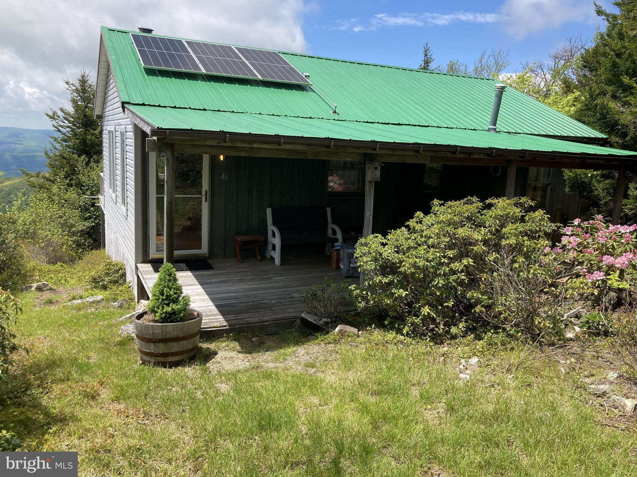 This lovingly maintained, cozy cabin on 5-acre lot in Kile Knob, offers a unique opportunity to have your off grid, dream retreat in a picturesque mountain setting. The property is characterized by its mountainous terrain, providing a sense of privacy and seclusion that is hard to find. Lush woodlands surround the area, enhancing the natural beauty and tranquility of the landscape. Imagine waking up to breathtaking views of majestic mountains and the soothing sounds of nature. The architectural style of the the cabin complements the natural surroundings, inviting you to immerse yourself in the rustic charm of mountain living. With plenty of room to roam throughout the development and access to an additional common area, this property is perfect for those seeking a peaceful escape or an adventurous lifestyle. The presence of a run-in shed adds functionality, making it ideal for hobbyists or those looking to store equipment. Conveniently located yet secluded, this lot offers the best of both worlds. Enjoy the tranquility of a peaceful sanctuary while being just a short drive from local amenities. This is more than just a piece of land; it's an invitation to embrace a lifestyle defined by nature, comfort, and endless possibilities. Don't miss the chance to make this extraordinary property your own. This cabin uses solar power and propane. The association fee includes road maintenance, however it is not always accessible throughout the winter months since there is no snow removal. Some covenants and restrictions apply.