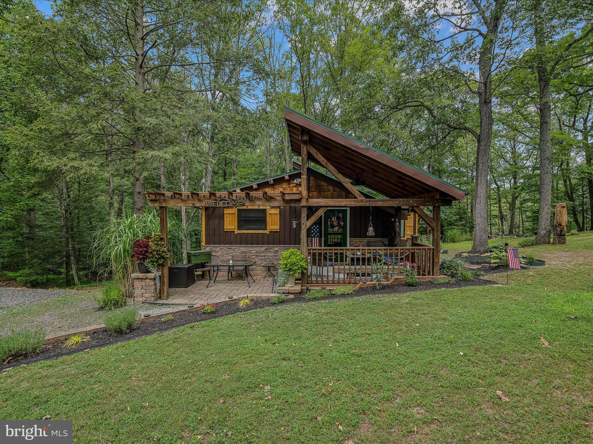 GETAWAY OR FULL TIME: don't miss this 2- bedroom 1-bathroom cabin on 2.06 acres. This cabin just feels like the perfect getaway the second you walk through the front door. It has a kitchen/dining combo, Livingroom with a woodstove, plus an electric fireplace, 2 bedrooms, an additional room that could easily become a 3rd bedroom, and laundry room. Home is equipped with a backup generator so life can go on when mother nature strikes. The outside is landscaped to catch your eye as you pull in the driveway. With the garage/outbuilding & shed you will have plenty of room to bring your toys. This subdivision offers a community lake for fishing and boating with a beach area for swimming, community pavilion and community ballfield. You can also access from within the subdivision the 22,000+ acres of Sleepy Creek Wildlife Management area for hiking or hunting. Just a five-minute drive to the well-known Wood Resorts two 18-hole Golf Courses. One is an 18-hole Championship Course & the other is an 18-hole mid-length course. Within 45 minutes of Whitetail Resort for skiing and less then 30 minutes from the Historic Town of (Bath)Berkeley Springs, WV. This cabin is within 2-hours from Baltimore, MD & Washington, DC