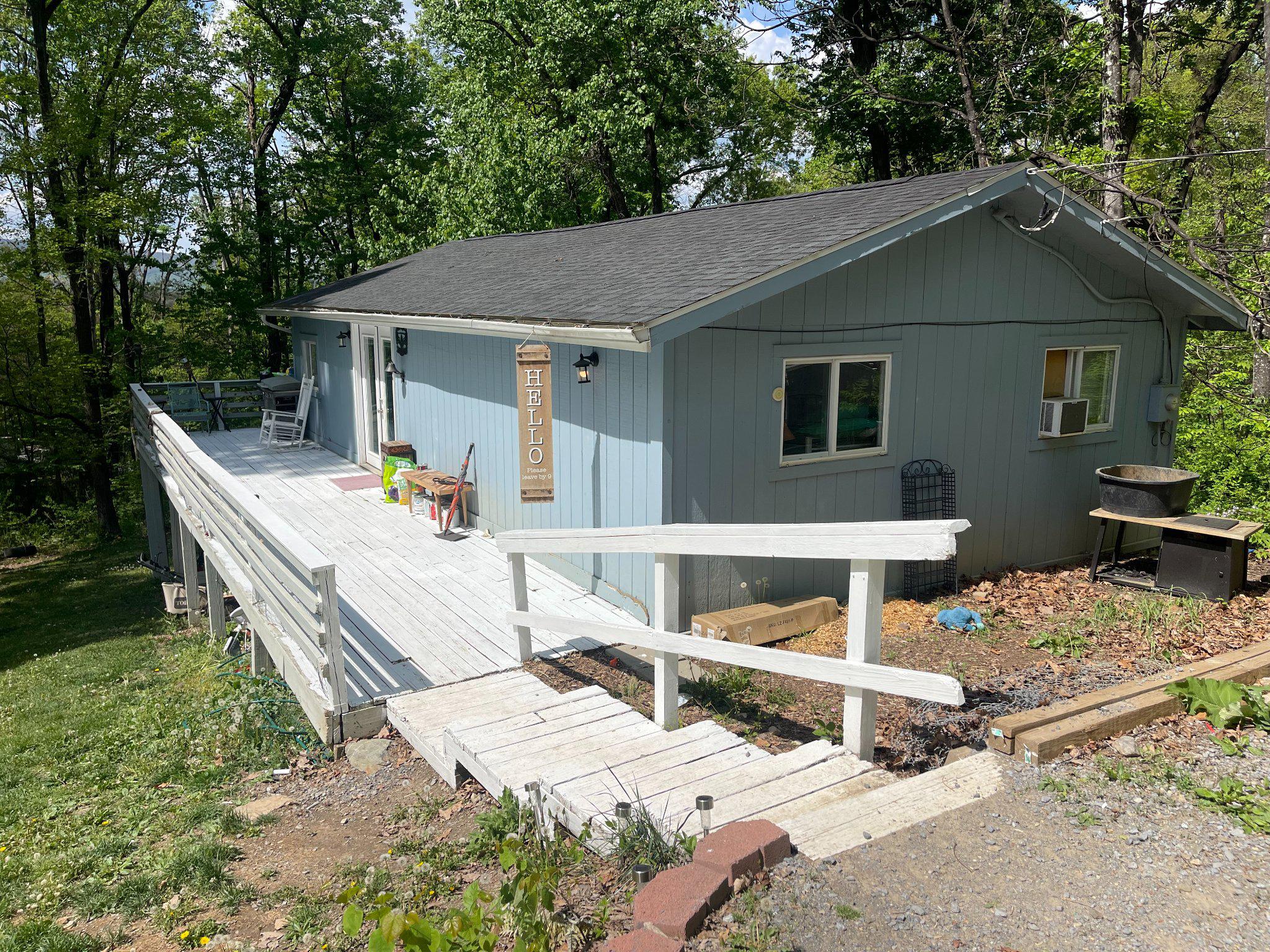 Tucked away in the wooded setting of Glenwood Forest, this ranch-style home offers a peaceful, private location with mountain and wooded views. The home features three bedrooms, one full bath, and an open living and dining area.

A wrap-around deck provides outdoor space to enjoy the surroundings, and the one-acre lot offers a mix of open and wooded areas with a sloping landscape. There is also a partial basement for storage and a gravel driveway with ample parking.

The home presents a great opportunity for buyers looking to put their own touch on a property in a quiet, natural setting. Conveniently located within a short drive to local amenities while still offering a sense of seclusion.