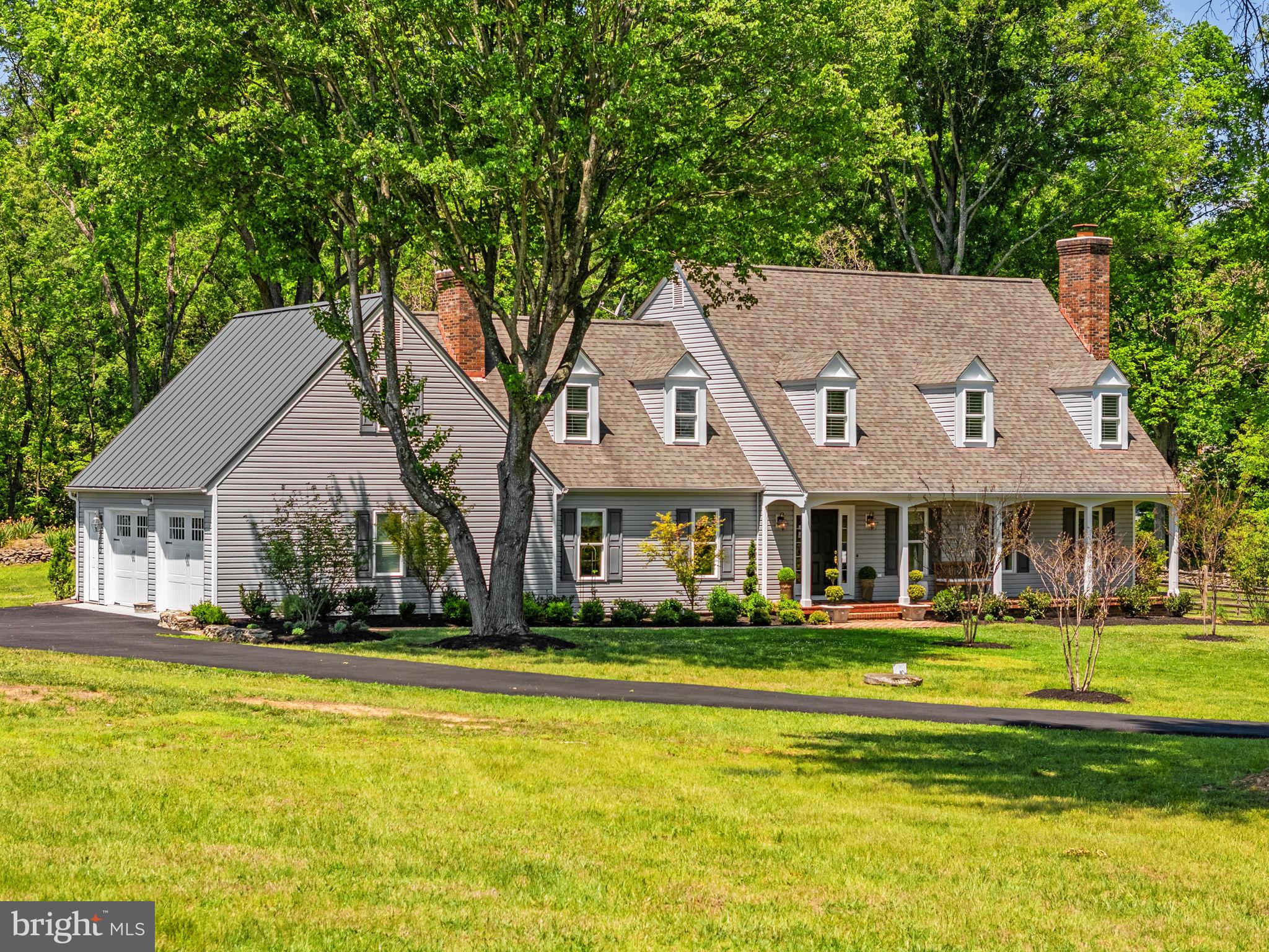 Desirable, updated home in the Melmore neighborhood of Middleburg.  Nestled on three acres, this Colonial Williamsburg home has been meticulously maintained and updated. Enter the gracious front porch into the formal foyer.  To the left is the large family room with gas fireplace and built in bookcases.  To the right is the formal living room with wood burning fireplace which opens to the formal dining room.  The adjacent, light filled kitchen, overlooks the large back yard and includes an area  for a family dining table.  A large mud room/laundry room and half bath with custom vanity and lovely finishes are also found on this level. Upstairs are 4 bedrooms. The large primary bedroom has two NEWLY REMODELED bathrooms--one with a tub, the other with a walk in shower. Abundant closet space and a separate dressing area  makes this suite even more desirable.  One of the other bedrooms includes an en suite bath. The other two share the use of the central, upstairs full bathroom. There is a large, walk up  attic space for future completion as living space or to be utilized now for added storage. There  is a large deck spanning the rear of the home. The grounds have been professionally landscaped and includes mature trees, stone walls, garden beds and is fenced for the safe keeping of pets or children's play. This is truly a delightful property, well suited for family living or a weekend escape in the country.