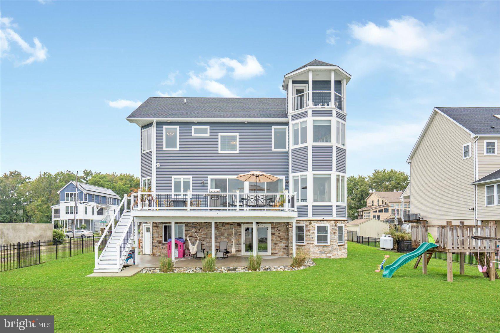 Welcome to Waterfront Living on Millers Island – Where small town Charm Meets Luxury
Experience the best of both worlds with small-town charm and unrestricted panoramic views of the Chesapeake Bay. This rare 90-foot wide DOUBLE lot is fully fenced and secured by a 16-foot commercial-grade gate, setting the tone for the elegance that lies within. The main-level bedroom is ideal as a guest suite or private office.
Designed for those who love to entertain, the main floor boasts 10’ ceilings, wide plank flooring, 8’ sliding doors, and large casement windows, all crafted to highlight the awe-inspiring water views. The open-concept gourmet kitchen features a 10’ island with seating for six, flowing effortlessly into a generous dining room.
Walk out to the composite deck for a front-row seat to 180-degree, unobstructed views—arguably the best in Baltimore County.
Upstairs, the primary suite is a private retreat, complete with a walk-in closet, luxurious en suite bath, Italian Carrara marble shower, and bidet. The home's crown jewel? A spiral staircase leading to a 4th-level rooftop balcony where sunrises and sunsets over the bay become daily rituals.
Additional highlights:
* Flood insurance only $549/year
* Elevator-ready shaft currently used as closet space
* Tesla EV charger already installed in the garage
* Rock bulkhead for wave absorption and shoreline stability
* New 60’ pier with additional dock poles for your boat or jet ski
* Adjacent property under construction
This is more than a home—it’s a lifestyle. Don’t miss your chance to own a one-of-a-kind Bayfront masterpiece on Millers Island.