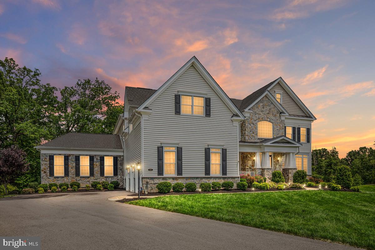 **OFFER DEADLINE MON 9/15 5PM**List Price is the Appraised Value on 8/25/25. Welcome to this extraordinary Toll Brothers Hollister Country Manor estate home, perfectly situated on a premium cul-de-sac lot backing to trees and open space in the prestigious gated golf course community of Dominion Valley Country Club. Built in 2019 this well crafted home offers an exceptional blend of architectural detail, luxury finishes, and resort-style outdoor living. Step inside the dramatic two-story foyer, where a dual-turned staircase, shadowbox molding, crown molding, and board-and-batten accents set the stage for the home’s refined character. The formal living and dining rooms feature designer trim details, while engineered hardwood floors flow seamlessly throughout the main level. A private office with custom built-ins provides the perfect setting for working from home. At the heart of the home, the ultra-chef’s kitchen is a true showpiece. Designed for both culinary artistry and entertaining, it features white shaker cabinetry with glass accents, under-cabinet lighting, an expansive island with pendant lighting, a commercial-grade range with vent hood, wall oven, granite countertops, a subway tile backsplash, a built-in 42” refrigerator, and a spacious walk-in pantry with wood shelving. Stainless steel GE Monogram appliances complete this gourmet space. Double sliding doors open to the backyard oasis, creating an effortless indoor-outdoor flow. The expanded family room, anchored by a marble-surround gas fireplace, is open to the breakfast area and kitchen, making it an ideal gathering space. The main level also features a multigenerational suite addition, complete with its own family room, spacious bedroom, full bath with walk-in shower, and a large walk-in closet perfect for guests or extended family. A custom mudroom with built-in drop zone and ceramic tile floors adds everyday convenience. Upstairs, the primary suite is a private sanctuary, featuring a tray ceiling, sitting room, and three custom walk-in closets. The spa-inspired primary bath offers a freestanding soaking tub, dual vanities, custom built-ins, a luxurious rain shower with bench seating, and a private water closet. Four additional spacious bedrooms, each with its own en-suite bath, complete the upper level. The finished basement provides an expansive recreation area, a stylish dry bar, a game area with Offenbachers game room included (shuffleboard, dartboard, air hockey, foosball, bar set with mirror, pool table and light fixture, stools, and billard rack), and a large storage room with potential for future expansion. Outdoors, no detail has been overlooked in creating the ultimate retreat. The backyard oasis boasts a heated gunite pool, spa, pavilion with a wood-burning fireplace, travertine tile, built-in ceiling heaters, expansive trex deck with built in kitchen and dedicated natural gas line, speakers, and multiple entertaining areas all surrounded by the natural beauty of the private, tree-lined setting. Additional highlights include Anderson windows, a three-car side-entry garage with openers and keypad, slate walkway and porch, and premium finishes throughout. As a resident of Dominion Valley Country Club, you’ll enjoy an unparalleled lifestyle with access to a renovated clubhouse, Arnold Palmer-designed golf courses, a sports pavilion, fitness center, indoor and outdoor pools, tennis and pickleball courts, basketball courts, sand volleyball, scenic walking trails, playgrounds, and stocked fishing ponds. Fitness and golf memberships are available, with award-winning schools located right inside the community. Convenient access to major commuter routes, as well as upscale shopping and dining, complete this incredible offering. Don’t miss the opportunity to call this exceptional estate home. Schedule your private tour today and discover a lifetime of Saturdays in Dominion Valley Country Club.