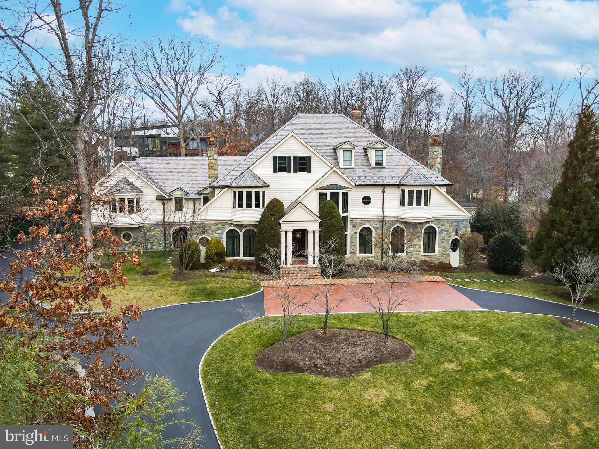 Come home to the definition of luxury in the heart of Potomac.  Built by acclaimed Gibson Builders, this breathtaking, one-of-a-kind property is filled with custom features, exquisite design and a warmth so rarely found in homes of its size. This home exudes high-end practical living with expert craftsmanship, a tasteful interior and thoughtful layout. The two-story grand foyer evokes Old Hollywood glamour with its curved staircase and gleaming crystal chandelier. To the right of the foyer is a formal living room with stone fireplace and hand painted ceiling by local artist Maggie O’Neill. The entire house has a gracious flow, leading from the living room to a stately clubroom, complete with a full wet bar and billiards space. This property is well suited for both large-scale entertaining or more intimate living. The centrally located great room serves as the heart of the home and is the perfect intersection of form, function and technology. Custom built-ins, a coffered ceiling and beautiful hardwood floors bring a warmth to such a grand space. The state-of-the-art drop-down movie screen makes this an ideal gathering spot for entertaining friends or cozy movie nights. Adjacent to the great room is a top-of-the-line chef’s kitchen with wooden ceiling beams, paneled appliances and an oversized walk-in pantry. There is an adjacent wet bar and sun-drenched breakfast room with direct outdoor access. The expansive formal dining room is the optimal space to host holidays and all of your special events. Take the elevator to the upper level which boasts six well-appointed bedrooms. The unparalleled owner’s suite has a sitting area, custom walk-in closet, luxurious bathroom for two with soaking tub and balcony access. The second jaw-dropping owner’s closet feels more like a boutique--it’s a fashion lover’s dream come true! There are five additional bedrooms on the upper level, all with  en-suite bathrooms and walk-in closets. One of the bedrooms serves as a spacious second owner’s suite with sitting area. An upper level bonus room with built-ins and a gas fireplace is the perfect flex space that can be used as an office, homework area, playroom, or meditation space. The lower level has a temperature-controlled wine cellar, full gym, massage area, sauna and spa shower/changing room. There is also an en-suite bedroom, additional wine room, a recreation area with bar and ample storage space. This property offers your own private Oasis with a beautiful pool and spa and handsomely landscaped grounds. Divine outdoor recreation extends from the covered stone patio to the built-in BBQ area to the custom pool house complete with kitchenette. Other amenities include a four-car garage, newly-renovated laundry room with steam machine and security system. This home is truly a masterpiece that will be cherished for generations to come. Minutes to Potomac Village with easy access to the DC Metro area.
