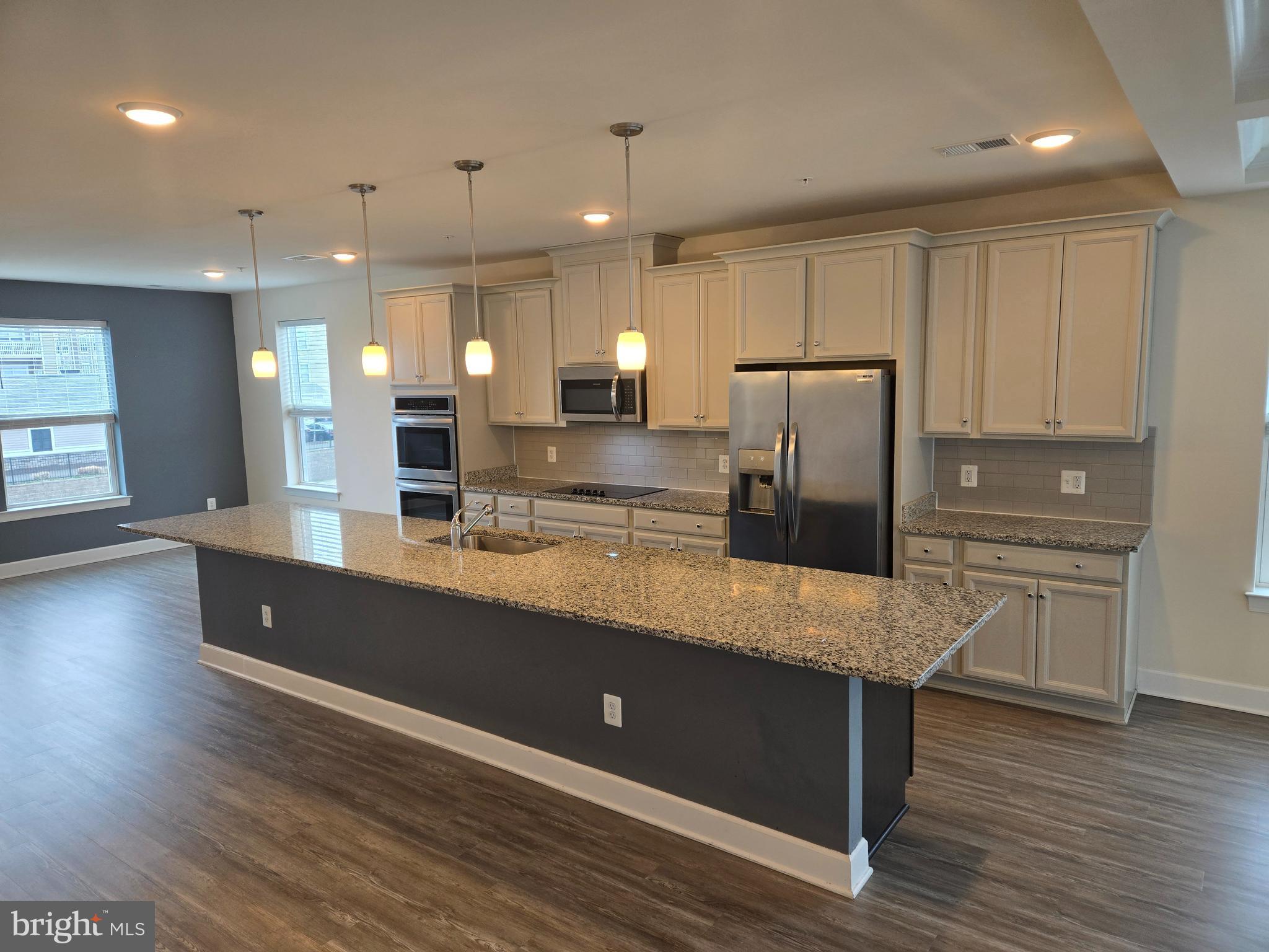 Built in 2020, quality end town home by Stanley Martin in sought after Arundel Mills location! Endless upgrades by the seller include: bright and open floor plan with loads of side windows; easy care vinyl plank floors throughout the main level; tall 9' ceilings throughout; chef's dream eat-in kitchen w/42" Timberlake flat panel maple cabinets, granite counters, grey subway tile backsplash, upgraded stainless steel appliances, double wall oven, built-in microwave, glass cooktop, under mount sink, pantry, expansive island, pendant lighting, recessed lighting and under cabinet lighting; family room w/upgraded coffered ceilings and slider to rear deck; main level powder room w/pedestal sink; upper level w/3 spacious bedrooms, 2 full bathrooms and laundry closet; owner's suite with a massive walk-in closet; owner's bathrooms w/walk-in tiled glass shower and separate make up vanity; 2nd full bathroom w/double sinks; relax on the rear deck w/illuminated railing caps; welcoming foyer; oversized 1-car garage; 30 year architectural shingled roof; high efficiency double pane, argon gas-filled windows; high efficiency Trane HVAC; H.E.R.S. rated home to ensure the highest level of energy efficiency resulting in a lower overall cost of home ownership. An amazing location to restaurants, shopping, mall, casino, major commuter routes and rails, Ft Meade, NSA and BWI Airport.