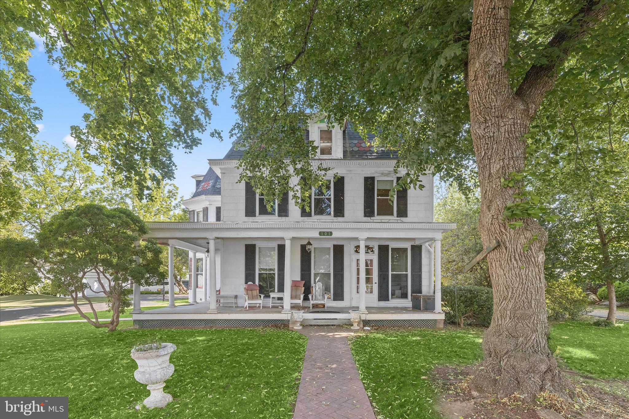 Welcome to 101 E Church Street, a rare opportunity in the heart of downtown Mount Airy where historic charm and endless potential come together. Built in 1909, this stately residence is rich with timeless character, offering the kind of craftsmanship and architectural beauty that simply cannot be replicated today. From the moment you arrive, the sweeping wraparound porch, grand architectural lines, and striking mansard roof create an unforgettable first impression. Replaced approximately eight years ago, the roof adds peace of mind while preserving the home’s historic elegance. Inside, soaring ceilings, oversized windows, and abundant natural light create a warm and inviting atmosphere filled with original charm and possibility at every turn.
This remarkable property is ready for restoration and vision, offering the chance to revive a true piece of local history into something extraordinary. The home’s graceful symmetry, spacious rooms, and undeniable presence make it a rare gem for those who appreciate historic homes and are ready to bring new life to a property with soul. It is more than just a house it is a keeper of memories, a place where stories have unfolded for generations, and where new ones are waiting to begin.
Additional features include secure storage, driveway parking, a covered wraparound front porch, balcony, and side porch spaces perfect for enjoying the charm and energy of downtown living. With its prime location, rich history, and incredible potential, this is a truly special opportunity to create something remarkable.