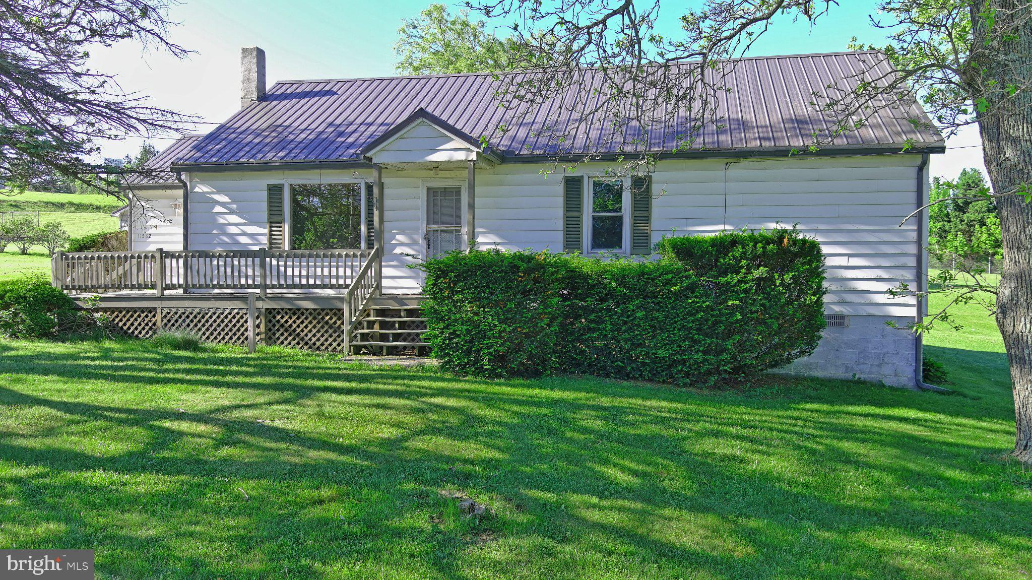 Charming 2 bedroom/1.5 bath home set on over an acre, offering space, comfort, and convenience. The home features a generously sized kitchen and dining room, with ample room for cooking and gathering. Upstairs, bonus flex space provides versatility and could easily serve as a home office, playroom, hobby area, or extra storage. A detached two-car garage provides plenty of storage and parking, while the expansive yard offers room to garden, play, or simply enjoy the outdoors. Conveniently located just minutes from groceries, restaurants, and everyday amenities, this property offers the perfect balance of peaceful living with easy access to town.