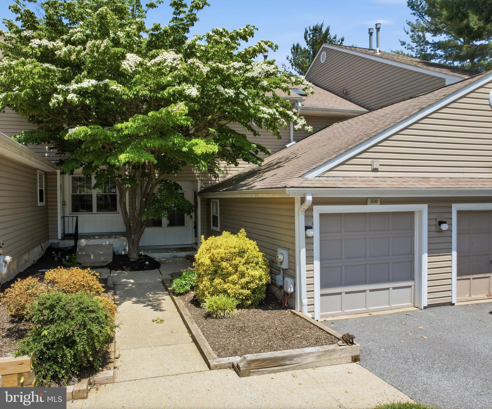 Welcome to Darlington Woods, located within the award winning Garnet Valley School District! This beautifully updated 2 bedroom, 2.5 bath townhome is one of the few units in the community offering a private garage, making it a truly rare find.

Step inside the welcoming foyer with rich hardwood floors flowing throughout the main floor, access to the garage, a convenient laundry area, coat closet, and an updated powder room featuring a newer vanity and toilet. The beautifully renovated kitchen offers white cabinetry, granite countertops, soft close drawers, pull out shelving, and a charming corner sink overlooking a sunny nook ideal for a breakfast table, home office space, or cozy coffee corner. Additional cabinetry and quartz countertop space provide even more storage and functionality, while the open sightline to the foyer enhances the bright and airy feel. 
The spacious living room has a brand-new wood burning fireplace with a new liner, recessed lighting, and abundant natural light. The dining area features an updated light fixture and a large sliding glass door leading to your own private concrete patio, which makes a great place to entertain or relax. Upstairs, the impressive primary suite feels like a private retreat which included vaulted ceilings, two closets including a walk-in with custom closet inserts, and a stunning spa-like bathroom. Truly a place to unwind in the oversized custom shower featuring body jets, a rainfall shower head, handheld wand, and built in concrete bench. The suite is completed by a beautiful, updated vanity, new light fixtures, tile flooring, and a large linen closet. The second bedroom is generously sized with a spacious double closet and wonderful natural light coming in through the large windows. A second full bathroom offers an updated vanity and ample space. Additional updates and features include a WiFi enabled HVAC system for convenient monitoring, a newer water heater, attic storage above the garage, and numerous thoughtful improvements such as a newer roof, HVAC system, and windows. The Darlington Woods Association provides stress-free living by covering exterior maintenance including the roof, siding, landscaping, snow removal, trash service, and maintenance of the community's outstanding amenities. Residents also have access to a swimming pool, fitness center, tennis and pickleball courts, recreation room, and beautifully maintained grounds. If you've been searching for low maintenance living with luxury touches, outstanding amenities, and a prime Garnet Valley location, this is the one you've been waiting for.