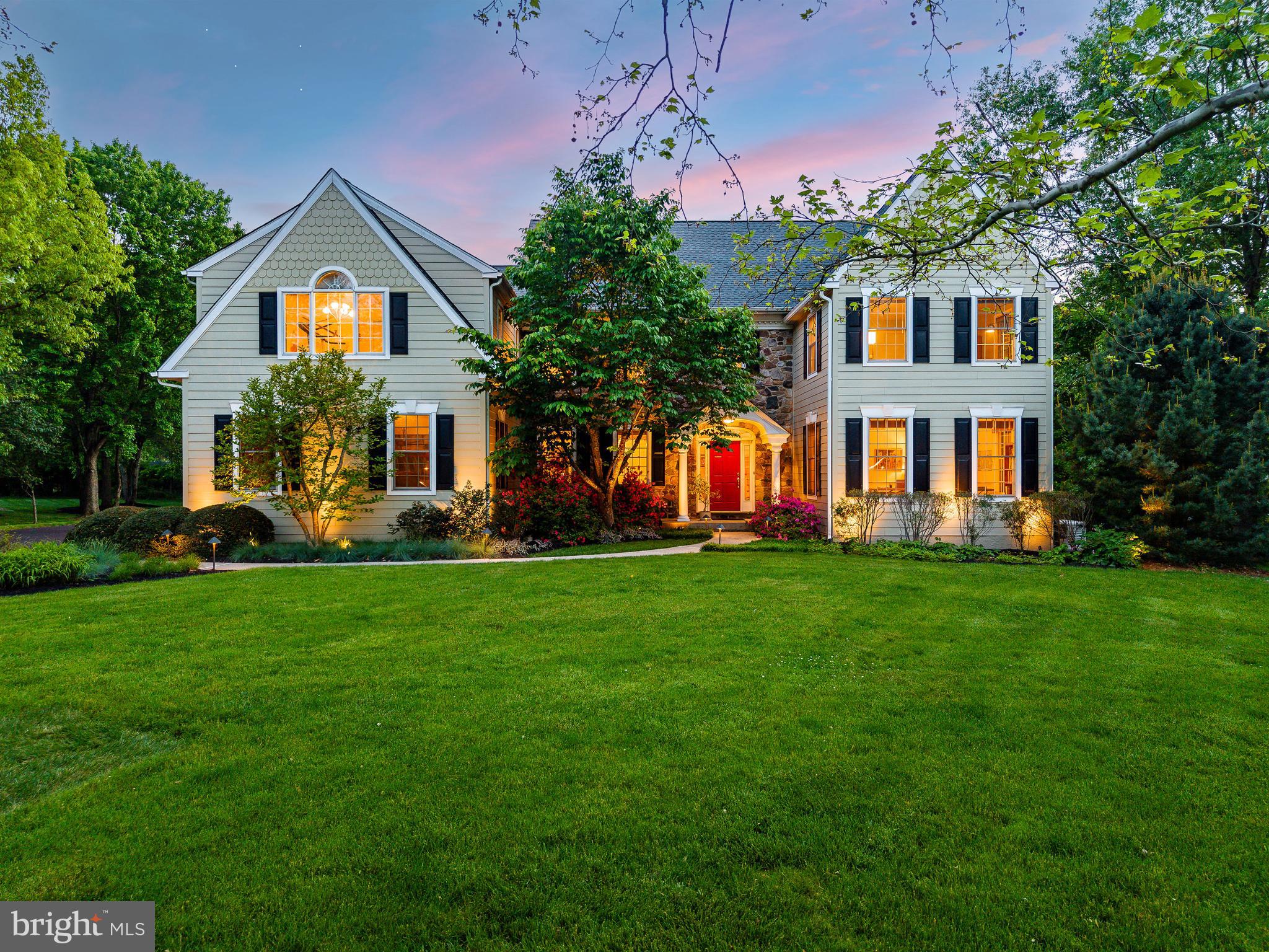 Perfectly positioned on a beautifully landscaped 0.92-acre corner lot in sought after Penn’s Crest, this expansive Guidi-built Colonial offers the rare combination of exceptional square footage, an outstanding floor plan, and one of Lower Gwynedd’s most desirable neighborhood settings. Flanked by walking trails and offering direct access to the path just beyond the rear yard, this is the kind of property where location and lifestyle come together effortlessly. Originally constructed as the builder’s model, the home was thoughtfully designed with enhanced architectural detail, generous room sizes, and a floor plan that feels both open and functional for modern living. Significant exterior improvements include the conversion from stucco to Hardie Plank siding in 2019 and a new roof installed in 2022—valuable upgrades that provide both aesthetic appeal and long-term peace of mind. With nearly 4,800 square feet of living space, 5 bedrooms, and 3.5 baths, the home was designed for both everyday living and entertaining on a grand scale. A dramatic foyer with recessed staircase creates an inviting first impression, while hardwood flooring extends throughout nearly the entire first floor. Unlike a more traditional center hall design, the layout here offers a natural openness and flow that today’s buyers crave while still maintaining the defined spaces that make a home feel warm and functional. The Living Room with gas fireplace seamlessly transitions into the Dining Room and onward to the expansive Kitchen, Breakfast Room, and sun-filled Solarium overlooking the deck, patio, and level backyard. The Kitchen has been refreshed with granite countertops and stainless steel appliances, but the true luxury is the space itself—offering endless potential for future customization and design. The adjacent Family Room, accessed by the rear staircase, features a soaring volume ceiling and impressive wood-burning stone fireplace, creating a dramatic yet comfortable gathering space. One of the home’s defining architectural features is the substantial front bump-out, carried through both the first and second floors, enhancing both the curb appeal and interior scale of the home. On the first floor is a spacious office, playroom, or flex-space with windows on three sides, offering exceptional versatility depending on the needs of the future homeowner. The second floor offers an expansive primary retreat complete with sitting room, oversized walk-in closet, and a spacious bath with timeless cherry cabinetry. An additional en-suite bedroom and bath, along with three other generously sized bedrooms sharing a hall bath, complete the upper level. The unfinished daylight basement—with exceptionally high ceilings, full-size windows, front and rear staircase access, updated mechanicals, and whole-house generator—presents an incredible opportunity for future living space. Whether envisioned as a media room, fitness studio, wine cellar, guest suite, or all of the above, the possibilities here are extraordinary. Located within the award-winning Wissahickon School District and just minutes from Whole Foods, Starbucks, Springhouse Shopping Center, the Ambler YMCA, regional rail, Routes 202 and 309, the Pennsylvania Turnpike, and downtown Ambler’s vibrant dining scene, this home offers the space, setting, and long-term potential that buyers wait years to find.