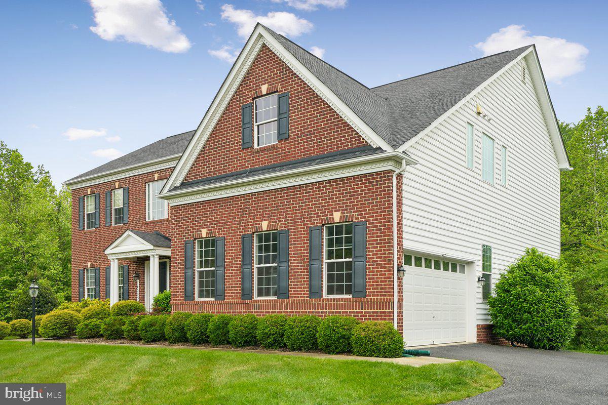 Why spend an insurmountable amount of money with add-ons for a new build home, when you can have a 5,000+ sqft, luxurious 5 bedroom 4.5 bathroom renovated estate, ready for your enjoyment; and at a fraction of the cost. Welcome to 14305 Dawn Whistle Way — a stunning estate tucked away on over an acre, on the absolute best lot in one of Bowie’s most desirable luxury communities. Built by Caruso Homes in 2016, this Monticello style home offers over 5,100 square feet of beautifully designed living space, blending timeless elegance with modern comfort, that create an atmosphere of comfort and sophistication throughout. From the moment you arrive, you’ll appreciate the home’s impressive curb appeal, spacious attached two car garage, and serene setting surrounded by mature greenery.

MAIN LEVEL FEATURES:    walk inside, where you will enjoy sun-filled interiors, generous living and entertaining spaces, and a thoughtfully designed layout ideal for both everyday living and special gatherings. The family room boasts a coffered ceiling with a row of 6 windows for uninterrupted view to your private acre woodland, perfect for you to enjoy nature. The main level also features a library with double glass doors, 10' ceilings and crown molding finishes throughout the majority of the main level. The gourmet kitchen features  huge island, plenty of counter space for cooking and an adjoining sitting area. 

UPPER LEVEL FEATURES:   Walk upstairs where you will find a enormously sized owners suite you will not believe!!! This primary suite takes your luxurious experience to another level, with key features that include-  a relaxing sitting area that boasts a gas fireplace, a walk in closet the size of a bedroom, an en-suite bathroom with a separate soaking tub and walk-thru shower platform. Upstairs you will also find a second bedroom with an en-suite bathroom and main hallway full bathroom. 

LOWER LEVEL FEATURES:   The finished lower level features a spacious bedroom, full bathroom, a recreation area, sitting area, and separate space for a home theater or gym. 
Situated on a private 1.1-acre lot, this home provides the perfect balance of peaceful suburban living with convenient access to major commuter routes, shopping, dining, a short drive to the Largo Metro Center, and everything the Bowie and Woodmore areas have to offer. A rare opportunity to own a distinguished property with space, privacy, and style, for a fraction of the price of a new build home this size and model, with all of these add on features.