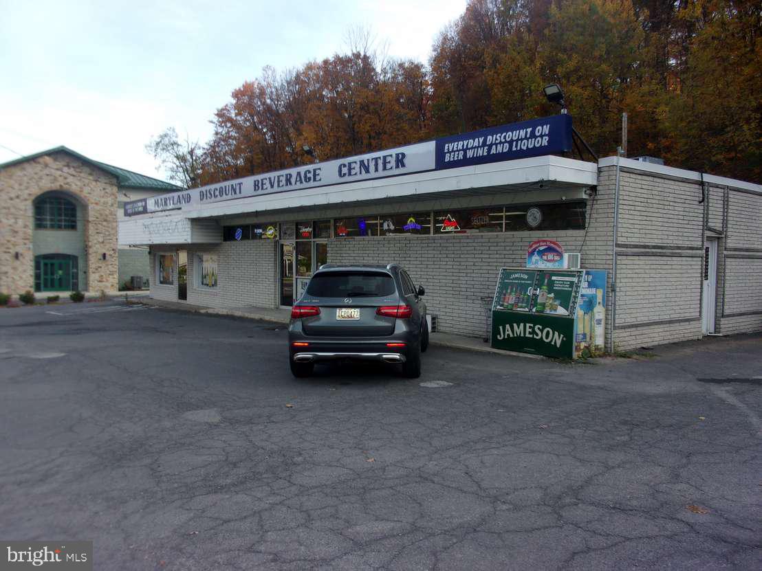 Large Retail building located along high traffic National Highway in LaVale.  Macadam parking, drive-up service window. Large lighted sign. Property is currently leased.  Copy of lease on file.