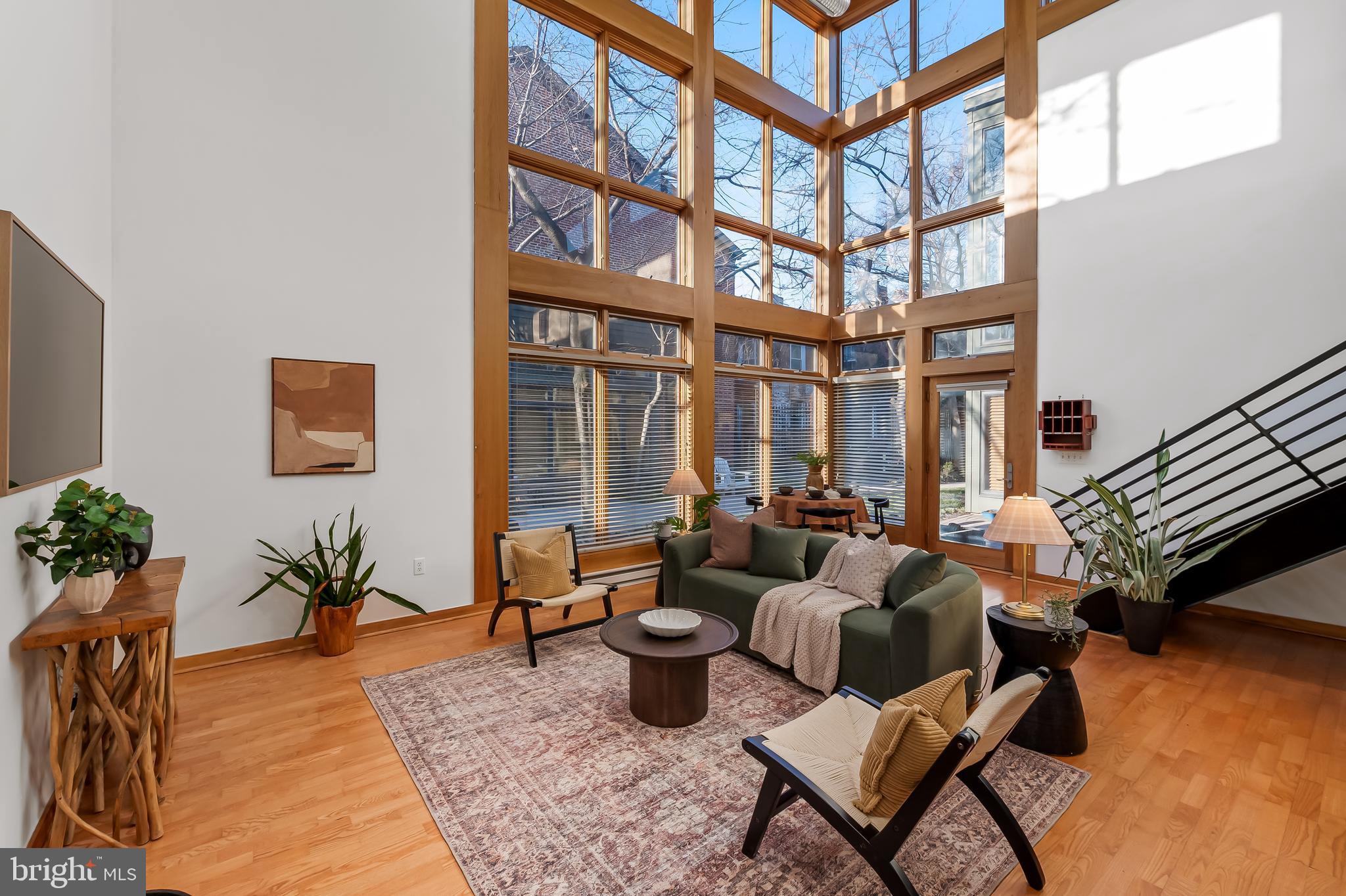 Offer Deadline: Saturday, March 15th at 12 pm! One of the most unique and highly coveted, gated rowhome communities in Baltimore. A one-of-a-kind contemporary in Ridgely's Delight, offering the feel of a single family home within a private, gated community. Featuring an open floor plan with a cozy wood burning fireplace, soaring 30-foot ceilings and a dramatic wall of windows overlooking a secure, professionally landscaped courtyard with cherry blossom trees... imagine the sights from your living room this Spring! Upstairs are two spacious bedrooms, each with an ensuite. Primary bedroom is also equipped with a private balcony and jetted tub. Large loft space overlooking the living room, perfect for an office or additional living area. Enjoy the security and convenience of an attached 1 car garage with suspended shelving, plus an additional parking space behind the garage. Bonus attached storage unit for even more storage. Nestled in the charming Ridgely's Delight neighborhood, this home blends tranquility with city convenience. You're just steps from Camden Yards, Conway Street Park and within walking distance to M&T Bank Stadium, the University of Maryland Medical Center, and the Inner Harbor. Quick access to I-95, 295, light rail, Metro, MARC train, and several bus lines, easily connecting you to downtown Baltimore, Washington, D.C., NIH, and Johns Hopkins campuses. 15 minute drive to BWI. Although the structure is similar to a rowhome, ownership is a condo. Monthly community fee covers water/sewer, all exterior maintenance repairs, groundskeeping, snow removal, and insurance. While the address is Washington Blvd, this home is tucked behind the front building on Washington Blvd and faces the courtyard in the front and an alley street in the rear, which has hardly any traffic. Truly a private oasis in the center of the city. Don't miss the chance to make this architectural marvel your own!