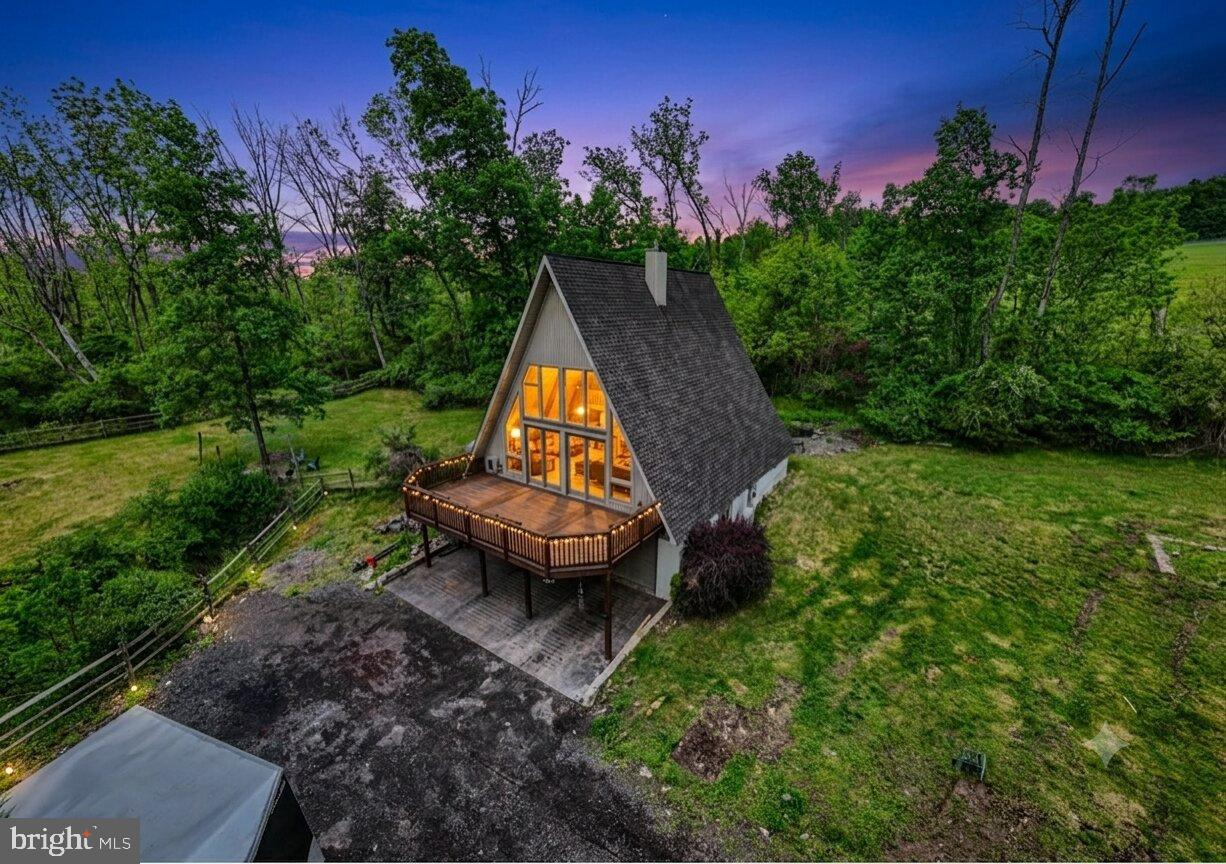 Welcome to this beautifully maintained, private A-frame retreat tucked away on a peaceful lot in Pottstown! This stunning home features a bright, open-concept main level with fresh paint, durable laminate flooring, an updated kitchen, and a first-floor laundry/mudroom. The dining area flows seamlessly into a dramatic two-story family room, anchored by soaring ceilings, a wall of windows flooding the space with natural light, and a gorgeous wood-burning stone fireplace. The flexible main-floor layout includes a spacious bedroom/home office with an adjoining full bath. Upstairs, escape to the primary suite complete with a private deck/sitting area, generous closet space, and a beautifully updated spa-style bathroom. 

BIG BONUS: The basement features a newly added 3rd bedroom equipped with its own mini-split system for personalized climate control!

Outside is an entertainer’s dream with multiple recently stained decks, a peaceful man-made pond, a fenced play area, and mature trees for ultimate privacy. A recently graveled, long driveway provides extensive parking leading to the oversized, detached 2-car garage with dedicated workshop space and extra attic storage. Mechanically sound with a brand-new water heater, 2-year-old well pump, 4-year-old HVAC system, and low-cost leased propane tanks (as low as $1/year). Conveniently located close to major commuting routes, shopping, dining, and entertainment. Move right in and enjoy!