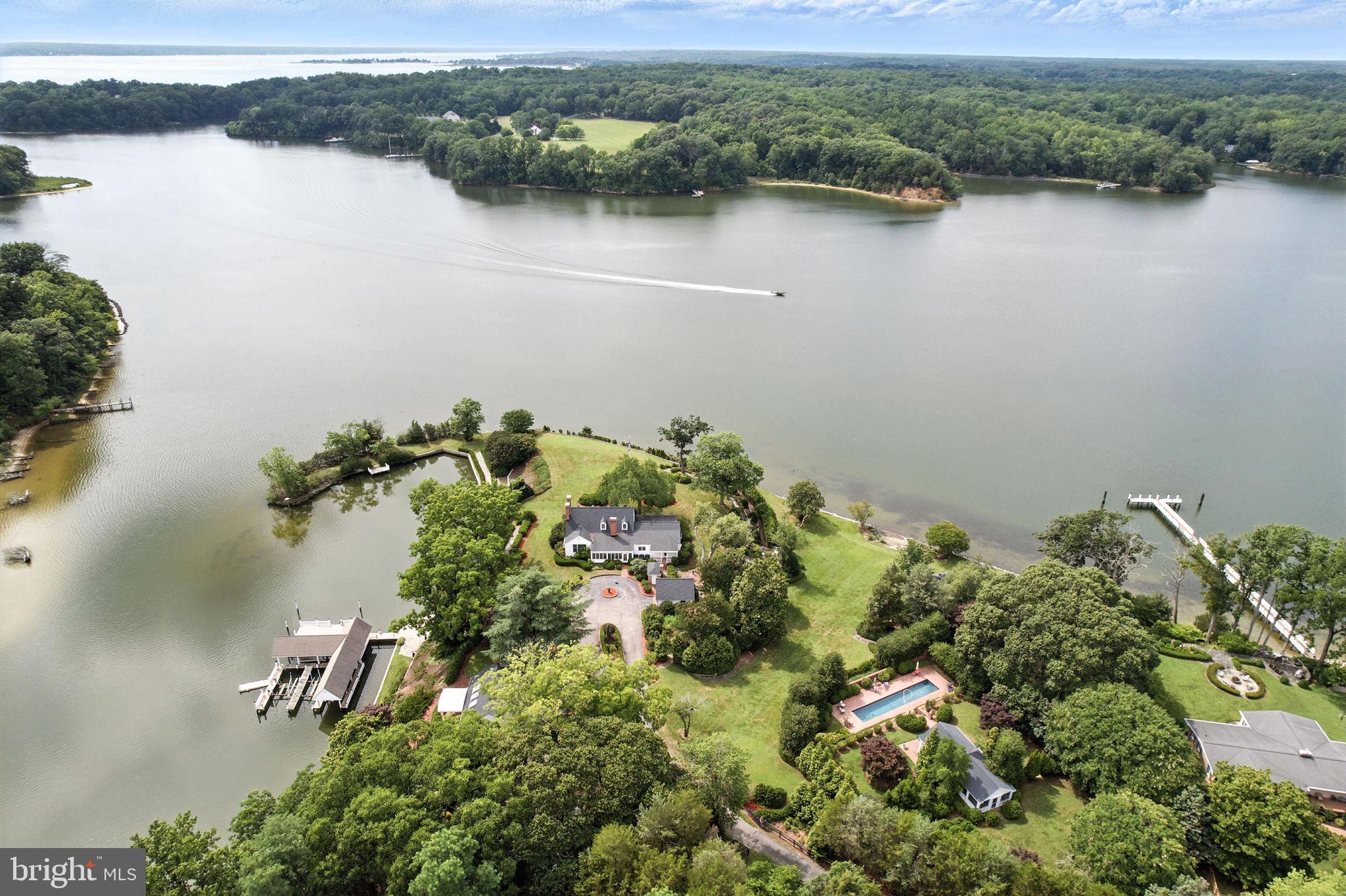 This spectacular waterfront on St Leonard Creek (close to the mouth of the Patuxent River & Solomons) has it all! PRIVATE 3.6 ACRES * OVER 1000 FEET OF WATERFRONT SHORELINE * Cape Cod MAIN HOUSE with 4 bedrooms/3.5 Bathrooms & high-end updates throughout * COVERED DOCK WITH MULTIPLE SLIPS & LIFTS * GUEST COTTAGE w/4th full bathroom * POOL HOUSE w/5th full bathroom and INGROUND POOL * 1-CAR DETACHED GARAGE & a second detached garage currently being used as a huge storage shed * PRIVATE  BOAT RAMP * Grounds have amazing stone walls, brick walkways, brick patios and private nooks * LUSH LANDSCAPING * FABULOUS WATER VIEWS  & SUNSETS! This is an estate sale so owner/trustee is exempt from disclosures. What a great opportunity to make this your unique waterfront retreat this summer! Enjoy the video!