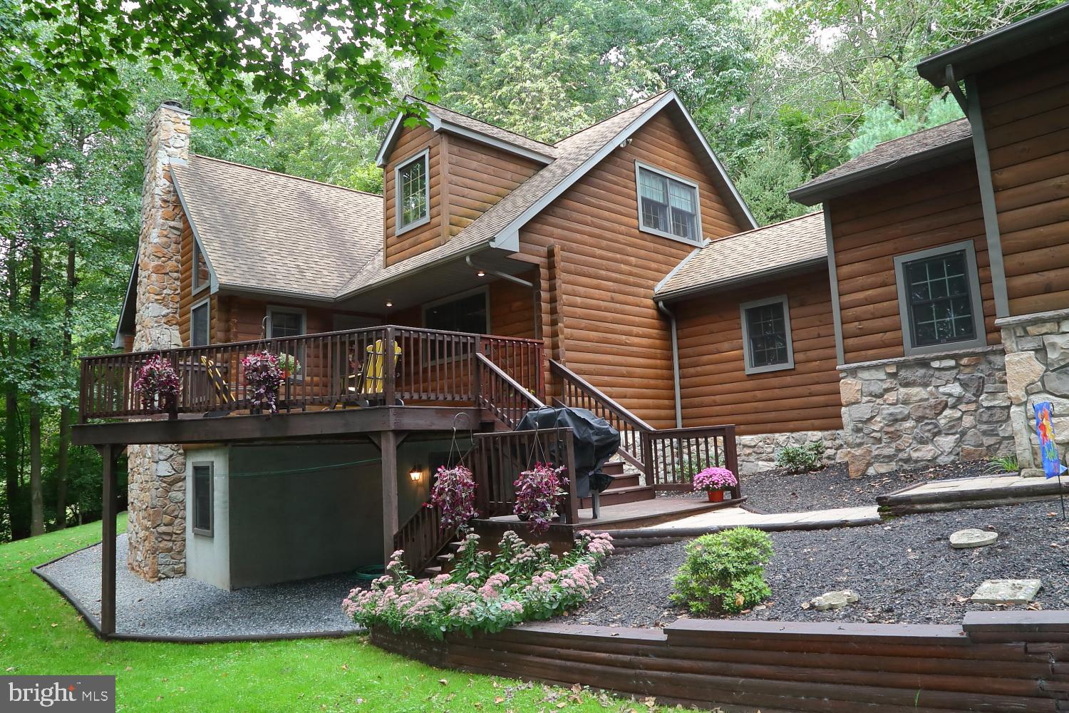 Nestled among the  trees off a private lane is this truly one of a kind custom designed log home.  The construction is  top notch and it was a labor of love as the owner oversaw it being built.  The property is 1.4 acres with a view to take your breath away.  Once you arrive here  it may be hard to leave.  The interior features an open floor plan with lots of natural light, a first floor den or office ideal if you want to work from home, a spacious bedroom with adjoining bath that has a whirlpool tub, a second floor loft commands a dramatic view of the great room, the lower level has a fifth bedroom, full bath, and an amazing game room with an exercise area too.  Come take a look at this gorgeous property today.  Also take a look at the floor plans and all other documents.  The ping pong and pool table is negotiable . Seller is related to real estate agent.