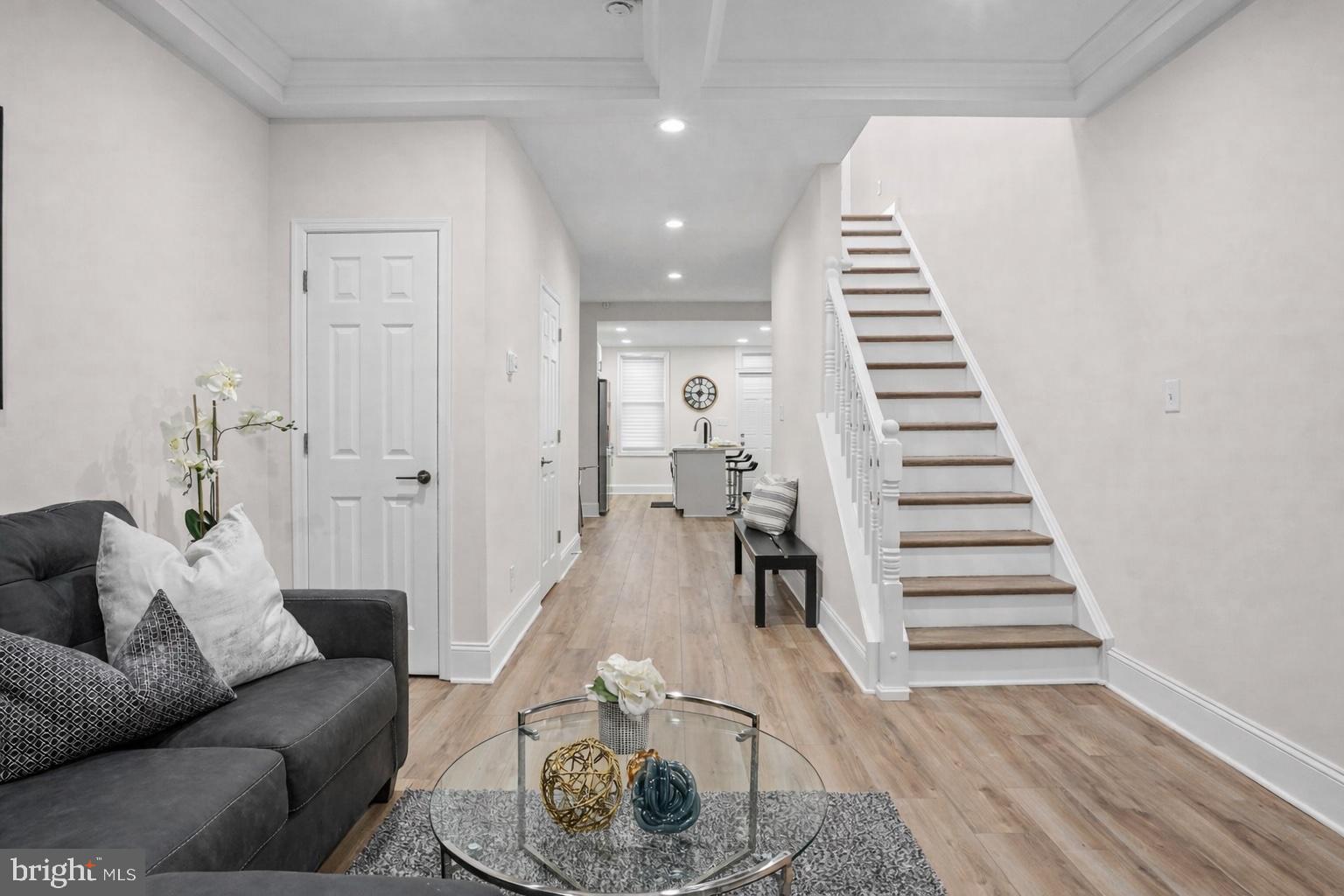 Beautifully renovated and move-in ready, this 2-bedroom townhome with a versatile middle room den offers style, space, and flexibility. Step in from the covered front porch to an inviting main level featuring luxury flooring, and recessed lighting. The open layout includes a spacious living room, dining area, half bath, and   kitchen with quartz countertops, stainless steel appliances, ample cabinetry, and an island with breakfast seating.
Upstairs, you’ll find a spacious secondary bedroom, a skylit middle room perfect for a den, office, or flex space, a beautifully renovated full bath, and a generous primary suite with its own private bath and luxuriously tiled walk-in shower. The finished lower level adds even more living space with a recreation room, storage, laundry, and a walk-out to the fenced rear yard.
Just off the kitchen is a newly constructed oversized wood deck overlooking the fenced yard, which also features a large patio/parking pad. Conveniently located near shopping, dining, and commuter routes, this home offers both comfort and convenience. Property may qualify for special financing programs offering below-market rates and down payment and closing cost assistance, subject to eligibility, program guidelines, and lender approval. Contact for details.