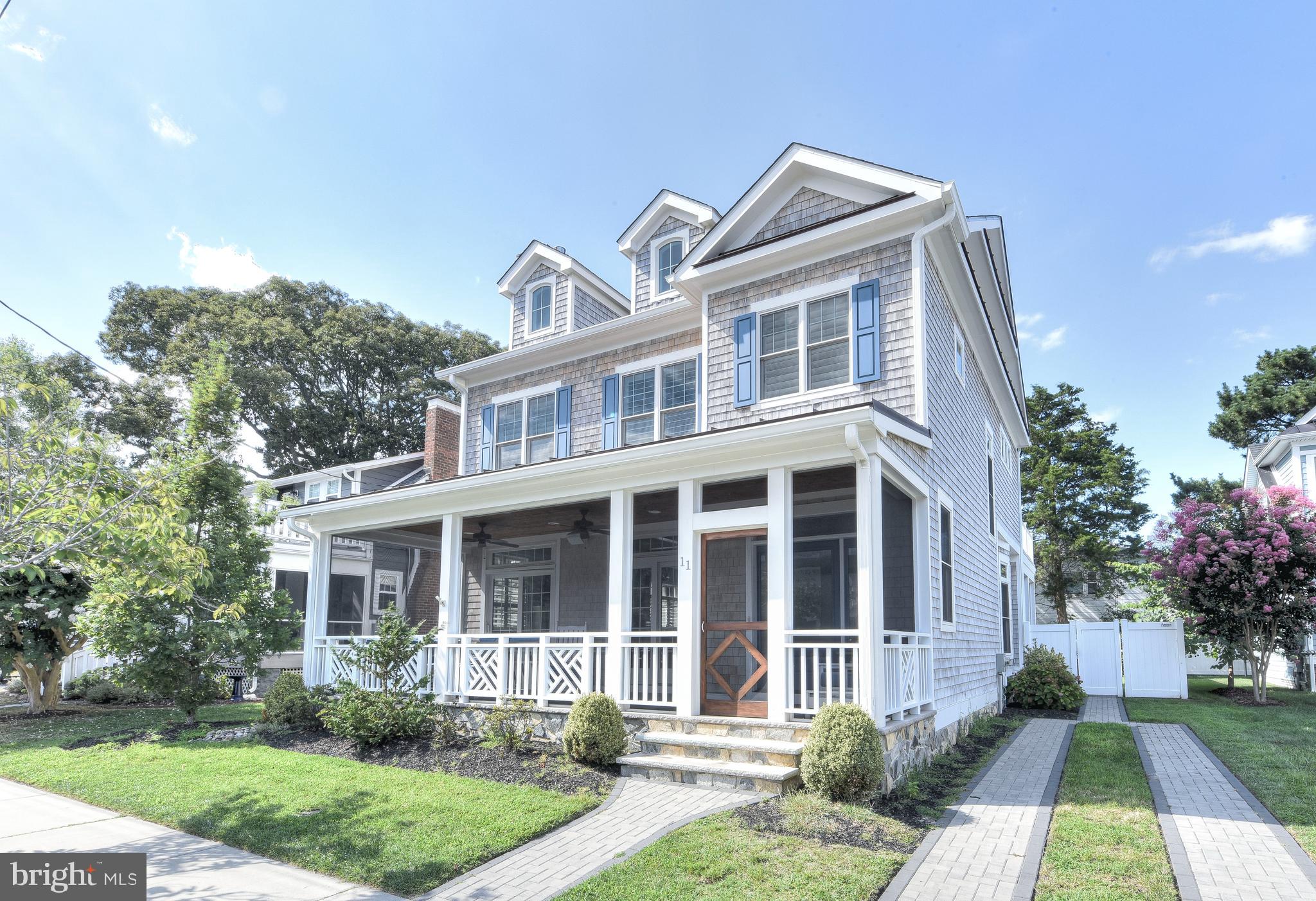 Oceanblock Stunner.  Never rented and occupied only part time, this exquisite 5 bedroom/5.5 bath custom-built South Rehoboth Beach home is located within 90 seconds to the Atlantic Ocean and boardwalk.  The floor plan was designed to emphasize an open living space, so you can appreciate the timeless upgrades from every point of the great room/kitchen. Living room features coffered ceilings, fireplace with stone surround, built-in shelving, milled-on-site wideplank oak flooring throughout and large windows/sliding doors with transoms that lead to the front screened porch. Gourmet kitchen with an extra large island, commercial grade built-in appliances-including a Sub-Zero refrigerator and a like new Wolf Range, a wet bar with beverage fridge and faucet with instant hot, a dining area with large round table,  all accented with Ann Sacks glass tiling and varying shades of white/gray and coastal blues. Hallway leads to laundry room with utility sink and storage, another screened in porch with two ceiling heaters for year round enjoyment and a first floor bedroom with double sink ensuite bath. Second floor leads to four other bedrooms, each with their own distinctively designed bathrooms. The primary bedroom has vaulted ceilings, its own thermostat, two closets -including a walk-in- and a private balcony. The bright primary bath has heated tile flooring, a luxury shower, soaking tub and water closet. Painted in deep blue with vaulted ceilings and shiplap walls, the third bedroom has two sets of custom-made bunk beds to comfortably sleep 5. Take in the natural light and soothing hues of the fourth & fifth bedrooms, each with their own baths. Full finished basement with luxury plank flooring and recessed lighting has several closets - one for the HVAC with Fresh Air Ventilation Control, one that holds the RTI Smart Home system & other controls, one for the sump pump with battery backup and a storage closet. Too many upgraded finishes to mention, but you will notice from the oversized solid wood doors to the cabinet hardware that this home has it all. Factor in that it comes beautifully furnished, closets outfitted, windows treated, outdoors landscaped and hardscaped with rear privacy fence and outdoor shower, you’ve got yourself a Lucky 11 Oasis.