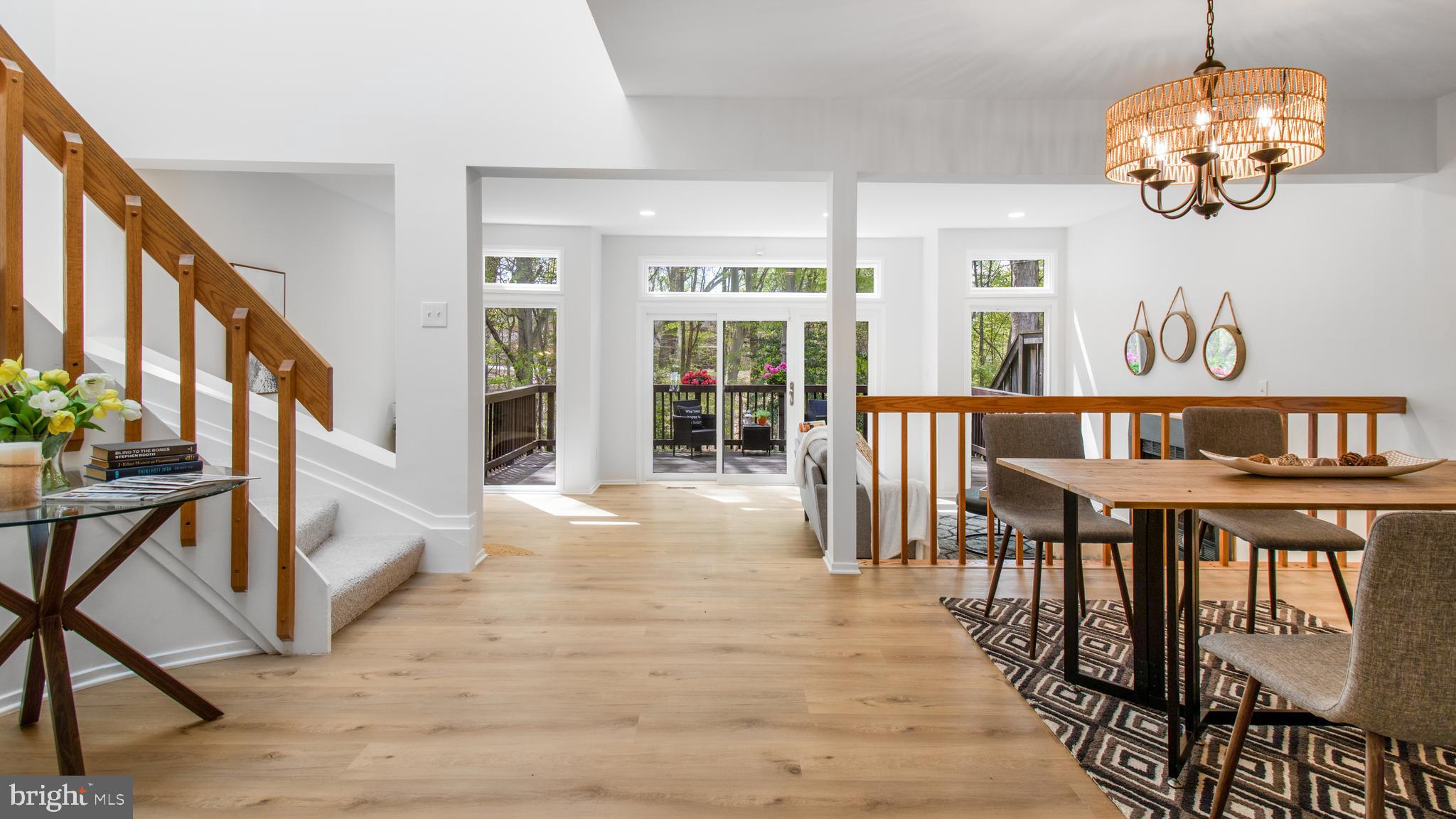 Fully reimagined for modern living and thoughtfully renovated, this exceptional townhome offers over 3,000 square feet of luxurious living space in the peaceful, sought-after Woodrock community. Set against a stunning parkland backdrop, this home brings the outdoors in, offering a lifestyle of natural beauty just moments from the heart of the nation's capital. 

A gracious stone walkway welcomes you to this beautiful home, where three expansive, light-filled levels blend timeless elegance with modern design. Inside, soaring vaulted ceilings, wide-plank modern flooring, and oversized windows frame spectacular views and invite natural light throughout.

The open-concept main level is a true showstopper, featuring a brand-new gourmet kitchen with a large quartz island, designer backsplash, and premium appliances. A separate dining room, a dramatic sunken living room with dual seating areas, a wood-burning fireplace, and a wall of glass overlooking the backyard create perfect spaces for both everyday living and entertaining. A stylish powder room and a sweeping curved staircase with skylights overhead add architectural flair.

Upstairs,  an expansive primary suite offers a private retreat with serene views, two walk-in closets, and a luxurious spa bath complete with a soaking tub beneath a dramatic skylight and a large walk-in shower. A light-filled hallway leads to the other end with an upgraded Hall Bath and two spacious Guest rooms. 

The fully finished, walk-out lower level features a bright family room with a second fireplace, a versatile bonus room ideal for an office, gym, or guest space, a full bath, and a laundry/storage room.

Outdoor living is equally impressive, with a deck and private backyard that open to tranquil parkland vistas—perfect for relaxing or entertaining. Completing the home is an attached garage with storage, a long driveway, and plenty of guest parking nearby.

Just a short walk to the C&O Canal National Historical Park, residents can easily enjoy miles of hiking trails, Potomac River access, and the stunning Great Falls overlook. In addition to its idyllic setting, this prime location is just minutes from the vibrant Potomac Village, offering everything needed for daily living, including grocery stores, restaurants, pharmacies, banks, Starbucks, and more!

Served by top-rated Carderock Springs Elementary, Pyle Middle, and Walt Whitman High Schools, and offering easy access to major commuting routes, this stunning residence offers the perfect blend of nature, convenience, and luxury living.

Welcome to Woodrock — where every day feels like a retreat.