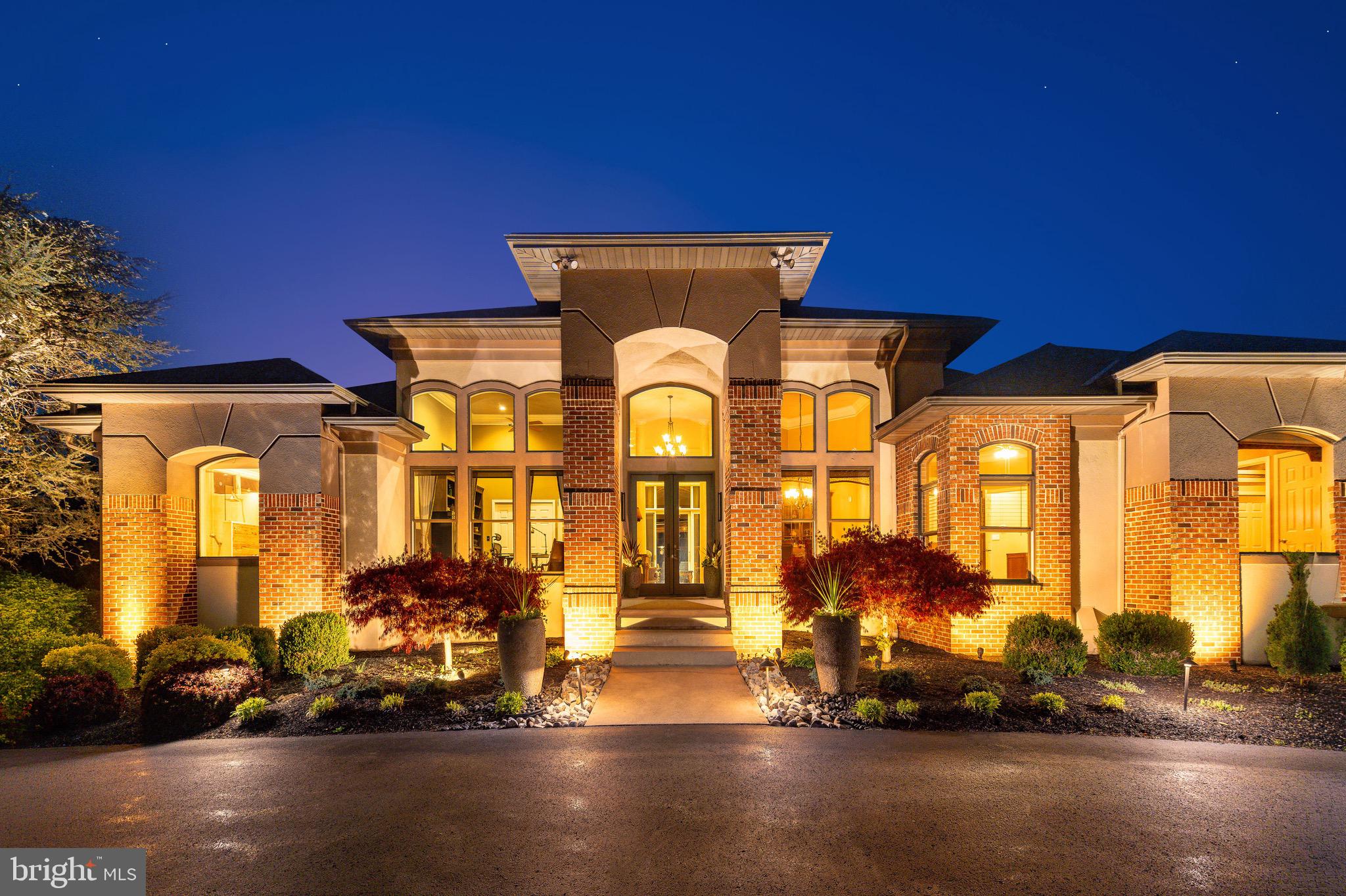 This exceptionally luxury residence offers over 5400 total square feet of living space, which includes over 3600 beautifully finished above- grade living space and an additional 1800 plus square feet in the fully finished lower level, creating an extraordinary amount of versatile living and entertaining space,  perfect for recreation, wellness, guests, or a private retreat. The home is set against the backdrop of sweeping panoramic vistas, this extraordinary 11-acre plus gated estate perfectly blends natural beauty, refined living, and premier equestrian amenities. A long, picturesque gated driveway leads you to the main residence, where expansive windows and outdoor living spaces capture stunning views from every angle rolling hills, open meadows, and spectacular sunrises and sunsets.

This elegant residence offers a warm yet sophisticated ambiance with soaring ceilings, sun-filled spaces, and a seamless open layout designed for both everyday living and elevated entertaining. The heart of the home features a beautifully appointed kitchen, expansive great room, and dining area that flows effortlessly into the main living spaces, anchored by a striking fireplace and complemented by easy access to a covered patio. A custom wine room with rich wood built-ins and a dedicated tasting area adds an elevated touch perfect for collectors and hosting. A distinguished executive home office featuring built-ins, premium finishes, and a quiet executive ambiance perfect for working from home. An elegant formal living and dining room offer timeless sophistication and exceptional flow for entertaining with family and friends. 

The outdoor living experience is truly exceptional, designed as a private resort. The heated in-ground pool with spa, (which can stay open year round due to separate pump and filter system), water features, and slide is surrounded by stunning hardscaping and ambient lighting. A beautifully crafted pavilion with lounge seating and a fire feature creates the perfect setting for entertaining or relaxing under the stars, offering a level of outdoor living that feels both luxurious and inviting.

For equestrian enthusiasts, the property is thoughtfully equipped with a well-appointed barn offering multiple stalls, a tack room, and storage. Expansive fenced pastures, turnout areas, a lean-to shelter, and an oversized riding ring provide an ideal setup for riding, training, or leisure. The acreage also allows for additional animals, gardens, outbuildings, or even a future guest house.

The grounds are meticulously maintained with extensive landscaping, hardscaping, miles of quality fencing, and a full irrigation system (excluding turnouts), all controlled through the Rain Dance app.

Modern technology enhances the home with whole-home audio powered by seven Sonos amps, smart lighting, Roku entertainment, and a commercial-grade WiFi network with multiple access points for seamless coverage throughout the home, grounds, and pool area, plus a backup Starlink system. This property has a 40 year Premier brand roof, 400 amp service, and 3 electrical panels. 

Security is comprehensive with Nest cameras, a high-tech gated entry system with video, voice, and keypad access, and a commercial-grade Verkada system. The pool is fully controlled via the Pentair app. Both the home and barn include monitored fire and CO2 systems, with lightning protection installed at the barn.

A dedicated theater room with zero-throw projection and surround sound, along with an additional system in the family room, completes the home’s entertainment offerings.

Ideally located in Hilltown, overlooking Roxborough and beyond, this private estate offers convenient access to Philadelphia, New York, and New Jersey, all within a top-rated school district.

Rarely does a property of this caliber become available offering a lifestyle defined by privacy, elegance, and exceptional indoor-outdoor living.