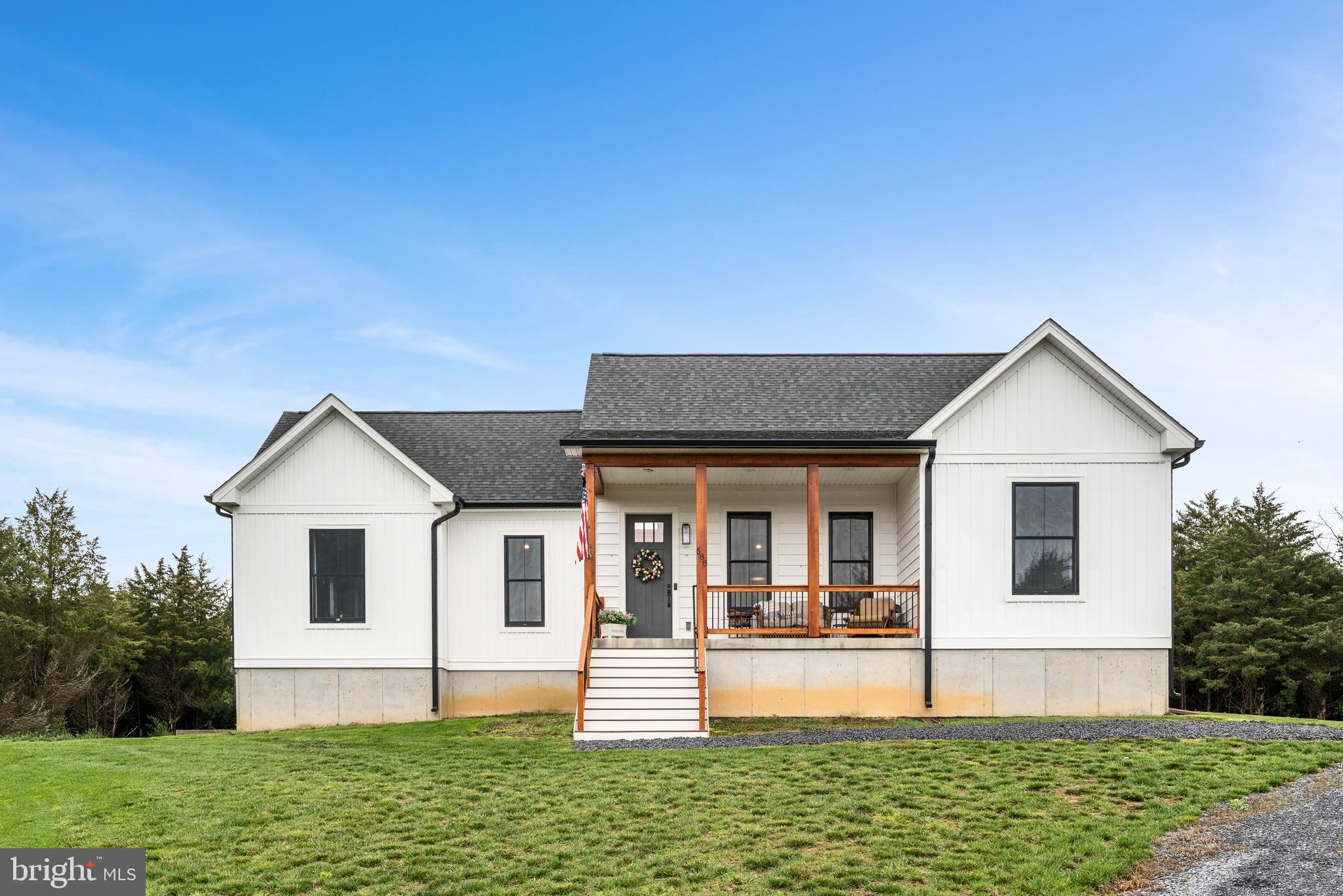 Stunning Custom Modern Farmhouse! This one-of-a-kind home offers single-level living with 3 spacious bedrooms and 2 full baths. The open floor plan boasts soaring cathedral ceilings in the living room, kitchen, and primary suite, creating an airy and inviting atmosphere. The stylish and functional kitchen, features upscale stainless steel appliances, large island with ample seating, soft-close cabinets and drawers. Cozy up by the fireplace wrapped in authentic barnwood, flanked by custom built-ins. The luxurious primary suite offers  double sinks, a jetted tub and walk-in shower for ultimate relaxation. A convenient laundry room adds to the ease of living, while the large unfinished basement provides endless possibilities for future expansion. 

  Unwind after a long day on the large front porch with beautiful cedar posts, or enjoy the rear porch, offering a shaded retreat perfect for grilling, watching wildlife, or sipping your morning coffee or evening wine.   All located on a private lot enclosed with cedars offering year round privacy.  This meticulously crafted home blends modern elegance with rustic charm.—truly a must-see!