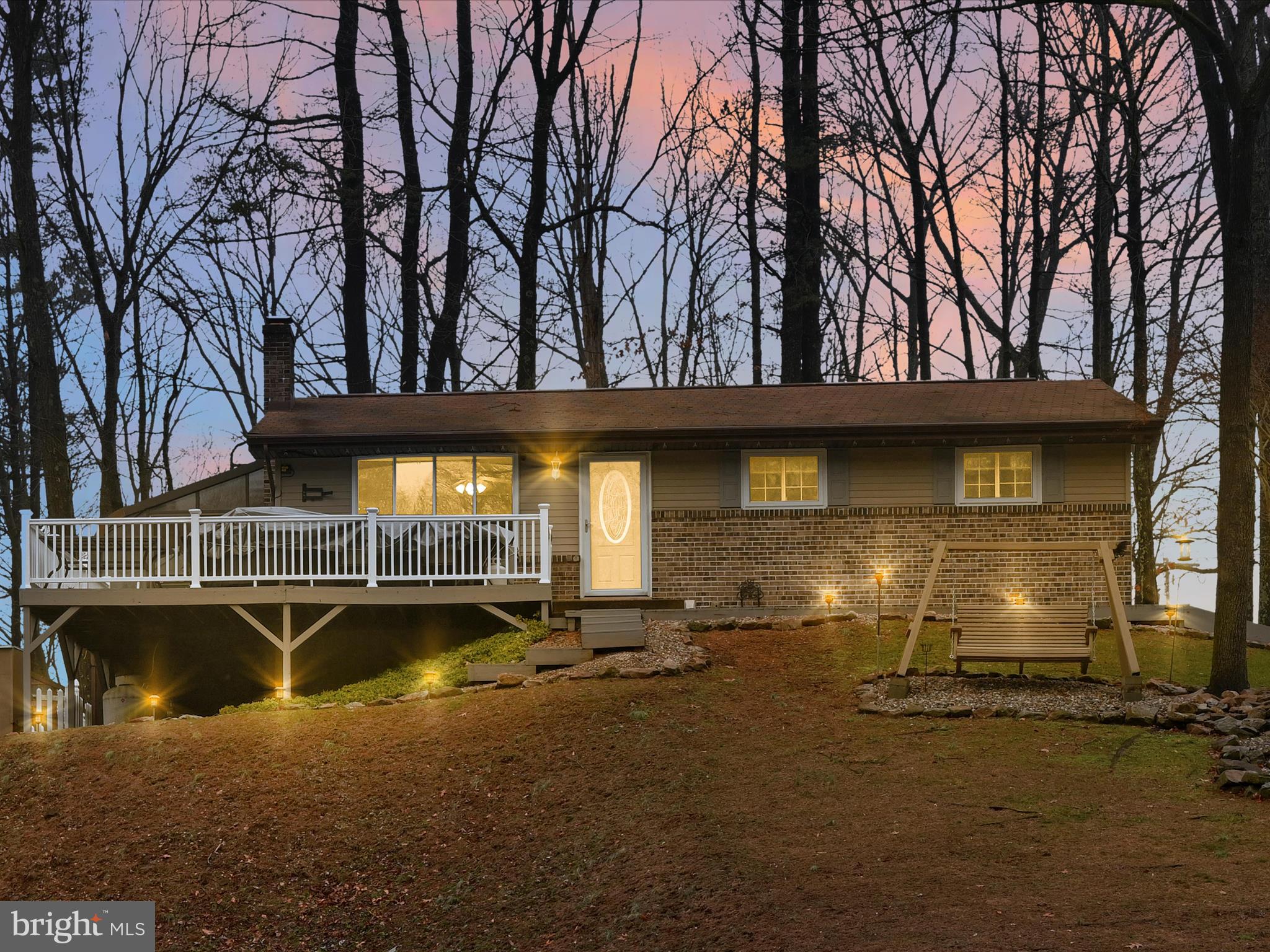 Are you seeking a home with a generous amount of land, complimented by water views, in the gated community of Lake Wynonah? Your opportunity to own this 3BR/1BA ranch on 1.0 acre awaits! This unique property offers buyers the potential for year-round lake views without the lakefront expense. Tax record #28-14-0815.000 included in the sale for a total of 1.0 acre. The main floor encompasses an inviting, open floor plan with updated kitchen, living room, 3 bedrooms, one full bathroom and a wrap-around deck with an enclosed glass sunroom/tiled bar area. It’s truly the perfect space for intimate family gatherings or summertime, entertaining fun! Spacious, wooden deck with vinyl rail and lighting. Full, finished basement with laminate flooring. A generous, unfinished area offers great potential for extra storage space or a workout area. Notable features include new furnace, central air and oil tank in 2022, replacement windows, radon mediation system, generator receptacle, one-car, attached garage. Two refrigerators, freezer, dishwasher, microwave and range included in sale.  Lake Wynonah is a gated HOA community featuring 2 gorgeous, pristine freshwater lakes (Lake Wynonah is approximately 90 ft. deep and Fawn Lake 45 ft. deep at deepest areas). Amenities include: business office/gathering room/library, lodge w/dining and bar, social clubs, boating, fishing, wakeboarding, waterskiing, tubing, paddleboarding, tennis, pickleball, several parks/pavilion, basketball courts, horseshoe pits, 2 pools, beautiful docks, hiking, natural wildlife and marina. Groups and events include: Active Civic Association, Dances/Concerts, Book Group, Pinochle Group, Volunteer Programs, Fish & Boat Group. Located less than an hour from Allentown, Harrisburg, Hershey and Reading. Deed Restrictions and By-Laws available. Beat the beach traffic and settle in at the lake! Truly, "Life on Vacation"!