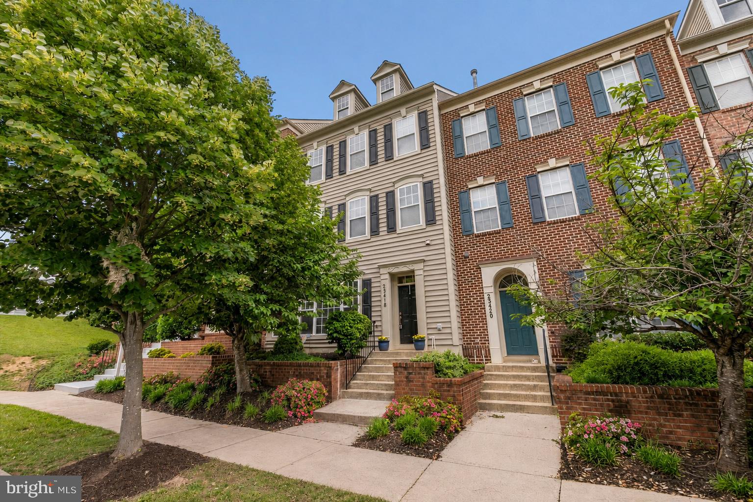 Nestled in the charming Clarksburg Town Center, this delightful Colonial townhouse offers the perfect blend of comfort, style, and modern living. Boasting 2,640 square feet of thoughtfully designed living space, this home features three spacious bedrooms, two full baths, and one half bath. The inviting main level is enhanced by soaring 10-foot ceilings that create an open, airy atmosphere throughout the family room and kitchen, while dramatic floor-to-ceiling windows in the family room flood the space with natural light. Beautiful hardwood floors, crown molding, recessed lighting, and a cozy gas fireplace add warmth and timeless appeal.

The gourmet kitchen is designed for both everyday living and entertaining, featuring an oversized center island, abundant table space, gas range, built-in microwave, and ample cabinetry. Upstairs, the spacious primary suite offers a peaceful retreat with a luxurious en-suite bath complete with an oversized soaking tub, separate stall shower, and generous space to unwind after a long day. The impressive top-level loft showcases vaulted ceilings and provides a versatile bonus space that's perfect for a home office, media room, fitness area, or guest retreat.

Step outside to discover a truly tranquil backyard oasis. The private patio is surrounded by mature, thoughtfully designed landscaping, creating a peaceful setting for relaxing or entertaining. A beautiful crape myrtle and colorful perennial gardens provide seasonal beauty and enhance the cozy, serene atmosphere of this inviting outdoor space.

Residents of Clarksburg Town Center enjoy an exceptional lifestyle with outstanding community amenities, including a clubhouse, fitness center, outdoor pool, playgrounds, parks, and scenic walking trails. Conveniently located near shopping, dining, and top-rated schools, this home offers the perfect combination of comfort, convenience, and community in one of Clarksburg's most desirable neighborhoods.