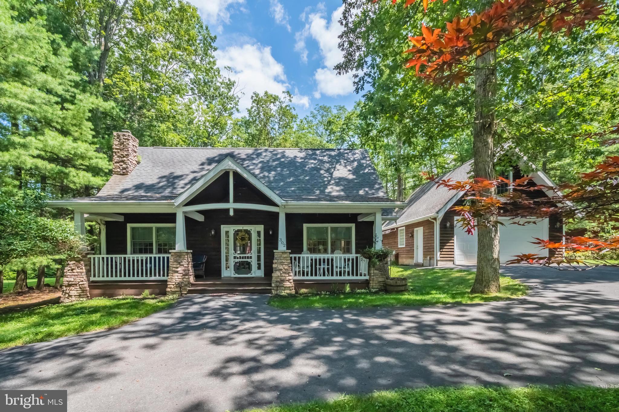 4BR, 4BA lake access cottage with assigned boat slip nearby! Incredibly cozy feel and impressive gas fireplace. Classic front porch area and a circular, paved driveway and over-sized detached garage with additional living space.  Amazing backyard is perfect for entertaining year-round -- spacious deck, fire pit and hot tub. Home is being sold furnished!  NO HOA - dock association only. The Harbor Association community dock has deep water access and is in a no wake zone, just a few hundred yards away.