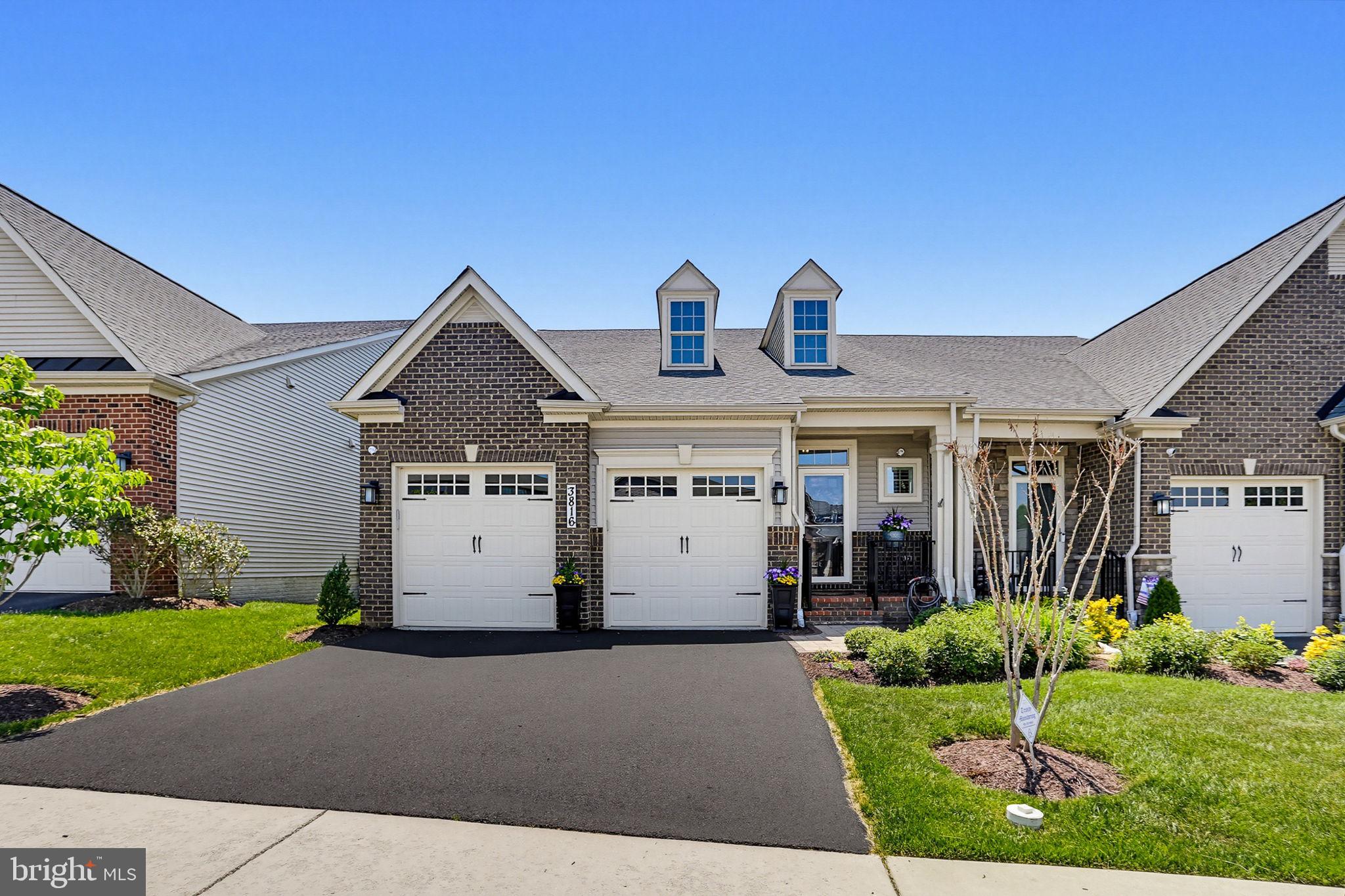 OFFER DEADLINE IS TUESDAY 5/26 AT 2:00 PM! AT Tucked within the sought-after Boxwood section of the Villages of Urbana, this beautifully appointed 55+ villa offers the rare combination of sophisticated main-level living, exceptional guest space, and an unmatched connection to nature and community. Backing to mature trees, walking paths, and protected green space with Urbana District Park just beyond, the setting provides a peaceful backdrop filled with scenic views, visiting wildlife, and a true sense of privacy rarely found.
Inside, rich hardwood flooring flows throughout the entire main level, where an open-concept design creates effortless everyday living and entertaining. The kitchen is thoughtfully upgraded with beautiful cabinetry, quartz countertops, stainless steel appliances, a five-burner gas cooktop, wall oven with built-in microwave, farmhouse sink, and expansive prep and gathering space. Adjacent dining and living areas feel bright and inviting, anchored by a dramatic coffered ceiling and a stunning floor-to-ceiling stone fireplace that creates an elegant focal point.
Large rear windows frame the natural surroundings and fill the home with light, while a covered porch extends the living space outdoors, the perfect place to enjoy morning coffee, quiet evenings, and the peaceful sights of deer and birds.
The main-level primary suite offers the comfort and convenience today’s buyers are seeking, complete with a tray ceiling,  hardwood flooring, tranquil green-space views, and a spacious ensuite bath featuring an oversized double vanity, tile flooring, and a beautifully finished frameless glass shower. Upstairs, a versatile loft creates an additional living space, while two generously sized bedrooms and a full bath provide ideal accommodations for guests.  A large conditioned storage room offers exceptional storage potential.  A private office with double French glass doors provides flexibility for working from home, hobbies, or a quiet reading space. The upper level creates a comfortable retreat for guests while still allowing homeowners to enjoy easy one-level living day to day. The finished walkout lower level expands the home even further with spacious recreation and gathering areas perfectly suited for movie nights, game space, family visits, or extended stays. A full bath, abundant storage, and additional flexible-use areas make this level as functional as it is inviting. Life in Boxwood offers more than just a beautiful home; it offers a lifestyle. Residents enjoy access to the Villages of Urbana’s exceptional resort-style amenities, including three pool locations featuring six swimming pools, three lap pools, and a spectacular resort pool complete with a lazy river, vortex, and water slides. Each pool complex also offers snack bars, locker rooms, and showers for everyday convenience. Additional community amenities include two fitness centers, tennis, basketball and pickleball courts, including indoor basketball and pickleball facilities.  Extensive hiking and biking trails connect residents to parks, green spaces, and the vibrant Market District filled with shopping, dining, and everyday conveniences, all just moments away. 
Residents also enjoy close proximity to the Urbana Regional Library, medical offices, and community gathering spaces. The Boxwood Villas community itself is especially beloved for its warmth, neighborly spirit, and active social atmosphere. Residents enjoy a private community garden complete with a potting shed and seasonal pick-your-own flowers and fresh herbs — a uniquely charming feature that reflects the close-knit nature of the neighborhood. An active social committee organizes year-round events and gatherings, including herb garden fire pit evenings, summer block parties, fall progressive dinners, winery and distillery outings, monthly wine tastings, pickleball groups, mahjong, bunco, golf outings, book clubs, garden committee, and numerous other interest groups.