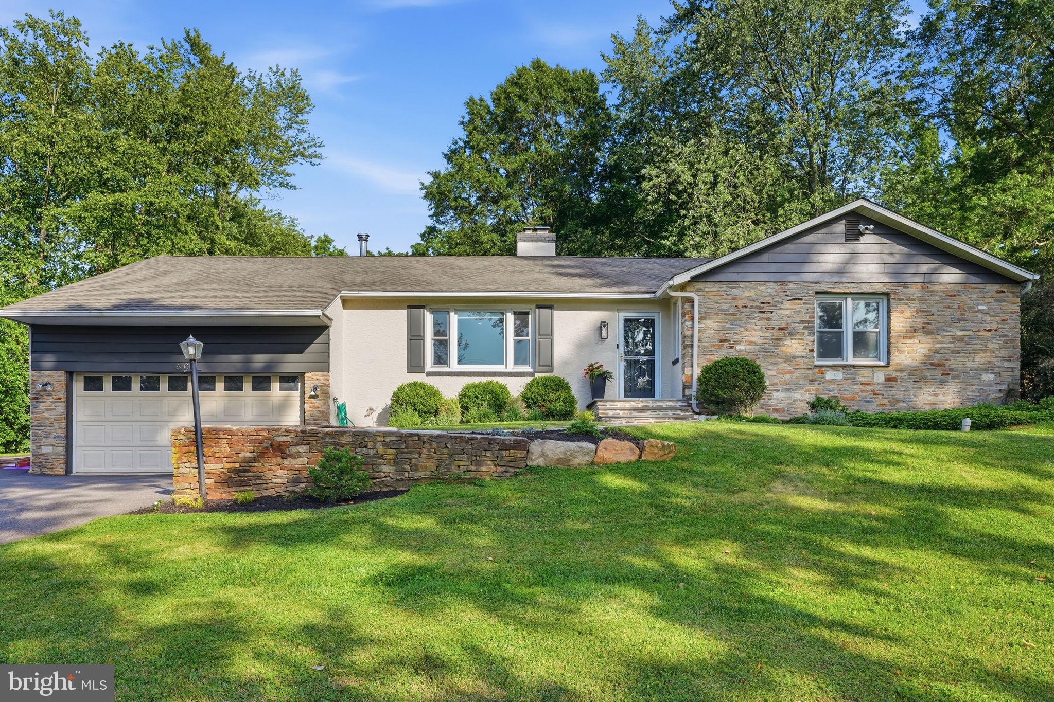 Welcome home to this beautifully maintained and thoughtfully updated ranch-style home, perfectly situated on a serene, tree-lined lot with an expansive backyard that is sure to impress. Offering a welcoming blend of modern updates and timeless charm, this home features an abundance of natural light, quality finishes, and versatile living spaces ideal for both relaxing and entertaining.
This home sits on a private 1-acre lot and boasts an open, sun-filled floor plan. The spacious living room features hardwood floors and a striking floor-to-ceiling stone fireplace. The family room/den offers rich wood paneling, beamed and vaulted ceilings, skylights, and a rustic wood-burning stove featured on a raised stone platform with beautiful stonework rising behind it. The gourmet kitchen has been beautifully updated with white quartz countertops, a large center island, Italian porcelain tile and radiant flooring, stainless steel appliances, vaulted ceilings, and multiple skylights that fill the space with light.
Comfortable bedrooms include a primary suite with a luxurious updated bath featuring marble throughout and radiant flooring, plus additional well-finished rooms with hardwood floors. The hallway bath offers a marble tub shower, quartz vanity top, and radiant flooring.
Outside, the expansive 1-acre grounds include a large composite deck perfect for dining and entertaining, mature trees, lush lawn, and raised garden beds. Additional highlights include a detached shed and attached garage. This move-in ready ranch combines single-level convenience, recent updates, and private outdoor tranquility on a full acre. Book your showing now before this must-see home goes under contract!