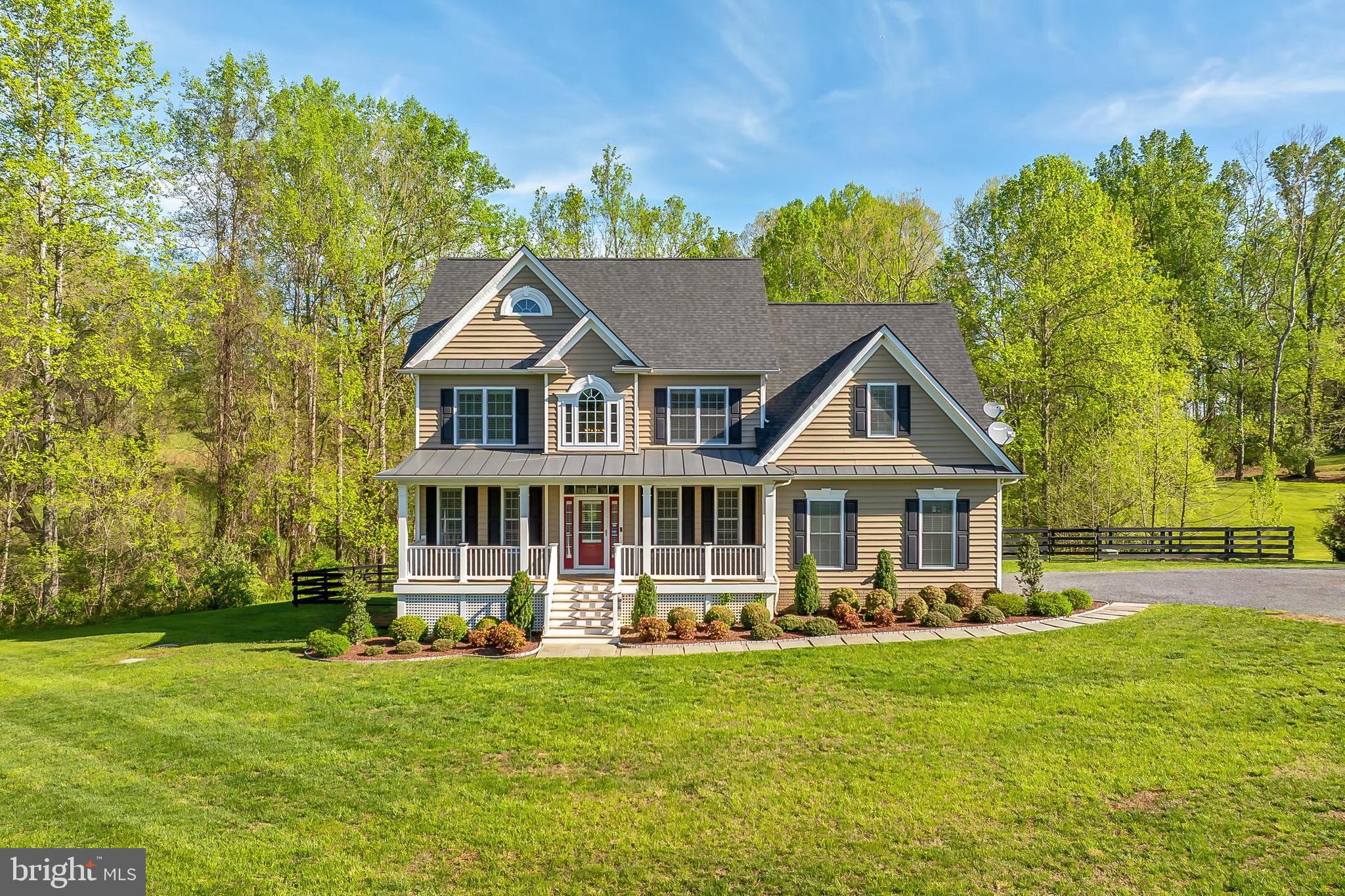 Welcome to 9480 Piney Mountain Road—a stunning modern farmhouse tucked away on over 5.5 serene acres in the heart of Virginia’s renowned hunt country. Featuring 4 spacious bedrooms and 3.5 bathrooms, this elegant home offers timeless style, a thoughtful layout, and picture-perfect surroundings including your very own private pond. From its classic front porch to the meticulously maintained interiors, this property blends charm, function, and sophistication in perfect harmony.

Step inside to a soaring two-story foyer with gleaming hardwood floors that flow throughout the main level. The light-filled living room offers a warm, inviting space to unwind or entertain, while the formal dining room is a showpiece of refined detail—complete with crisp crown moldings and a statement-making orb chandelier. The heart of the home is the chef-inspired kitchen, boasting granite countertops, handcrafted cabinetry, and premium stainless steel appliances—including a gas cooktop with a sleek, suspended hood. Whether you're enjoying breakfast at the peninsula bar, sipping coffee by the bay window, or lounging in the adjacent family room, this space is built for connection and comfort. A well-designed mudroom with built-ins and a stylish powder room add everyday convenience.

Upstairs, the luxurious primary suite invites relaxation with its tray ceiling, cozy sitting area, generous walk-in closet, and a spa-like en suite bath featuring dual granite-topped vanities, a deep soaking tub, and a frameless glass shower. Three additional bedrooms share a beautifully designed dual-entry bath with separate vanity space—ideal for busy mornings. A full laundry closet with updated machines completes the upper level. The finished walkout lower level offers even more versatility: a spacious recreation room perfect for movie nights or game days, a full bath, and a flexible bonus room ideal for guests, a home office, or gym. There's also abundant storage to keep everything neatly tucked away.

Outside, the peaceful acreage, lush lawn, post-and-rail fencing, and scenic pond provide the ultimate backdrop for outdoor living and entertaining. Though surrounded by nature, you’re just minutes from the shops, dining, and charm of downtown Warrenton, with easy access to Washington D.C., Fredericksburg, and beyond. This is more than just a home—it’s your own private retreat. Discover timeless design, modern comfort, and the beauty of country living at 9480 Piney Mountain Road. Welcome home!