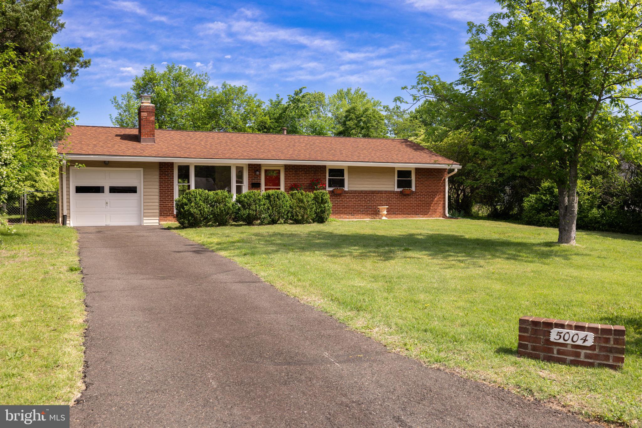 Welcome to 5004 Eastchester Circle, a terrific 3-bedroom, 2-bath brick rambler backing to trees on a quiet cul-de-sac in Alexandria’s popular Rose Hill Farm. This home has a 1-car attached garage with a lofty vaulted ceiling, a long driveway that can fit many guests and is sited on over a quarter-acre lot. It has been freshly painted throughout, and is light and bright and cheerful. The living room has a sunny bay window and a classic wood-burning fireplace with a brick hearth. There is ceramic tile flooring in the kitchen and dining room. French doors lead from the dining room to a wonderful sunroom with views of the private back yard - perfect for relaxation. The kitchen has a peninsula with extra counter space, a white tile backsplash and window looking out to trees. New carpet has been installed in all three bedrooms. Both full baths have been totally renovated with new modern vanities, tile floors, new mirrors, toilets, lighting and custom tile up to the ceilings! There’s a long list of updates: a new roof in 2020, new windows except the bay window in 2021, baths updated in 2021, new hot water heater in 2023, garage door in 2019, HVAC in 2018 and the sewer and water lines were replaced in 2015. This fine property close to Metro, all commuter routes, two town centers and just a quick hop to Old Town Alexandria!